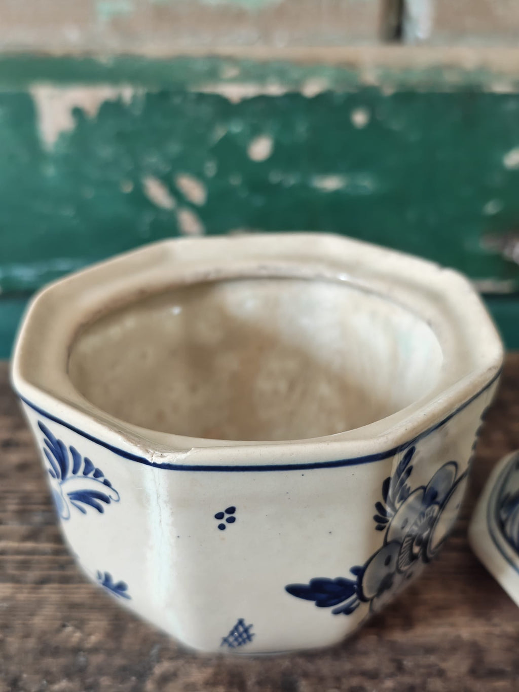 A vintage blue and white hand-painted stoneware sugar bowl showing interior