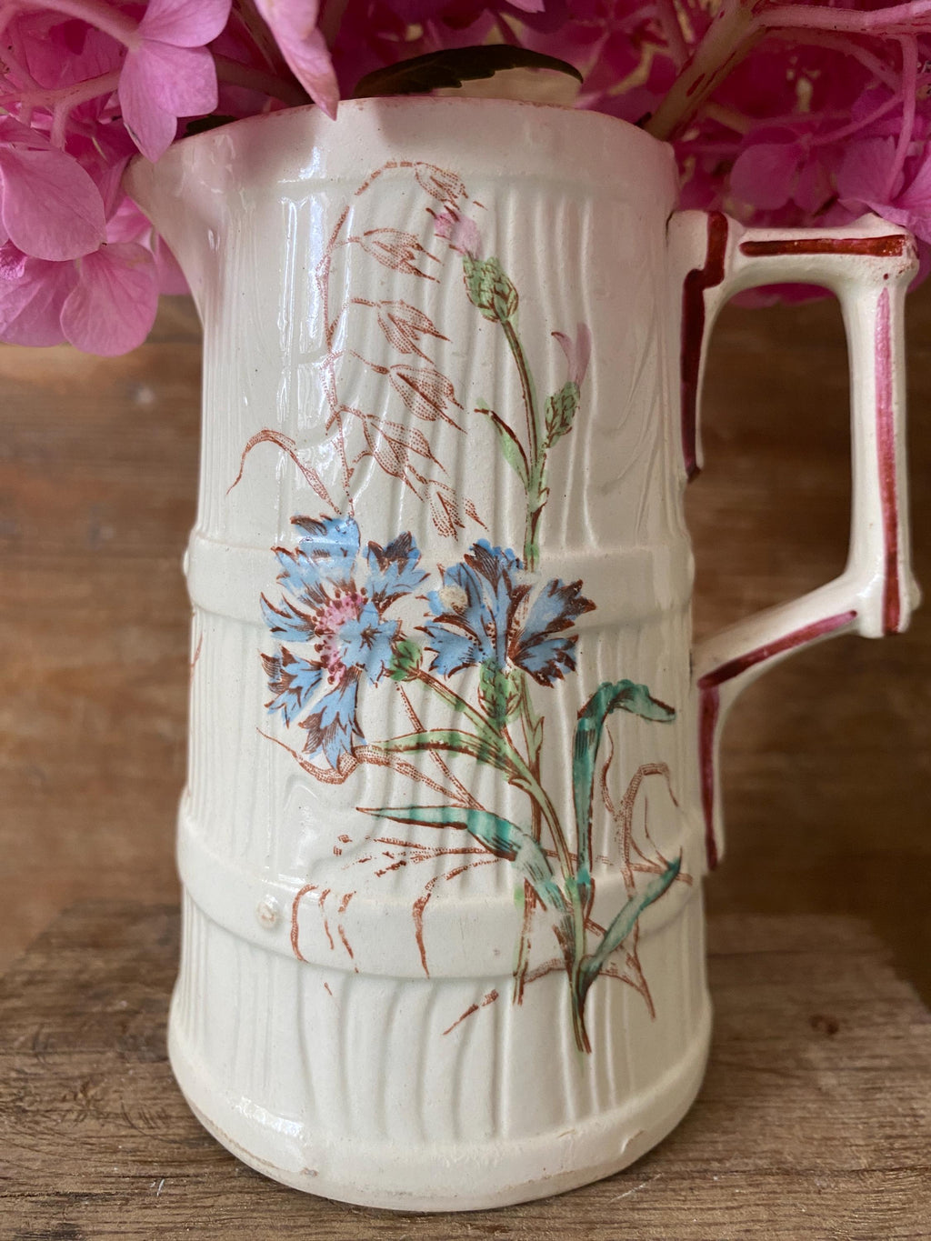 White ceramic pitcher with floral design 