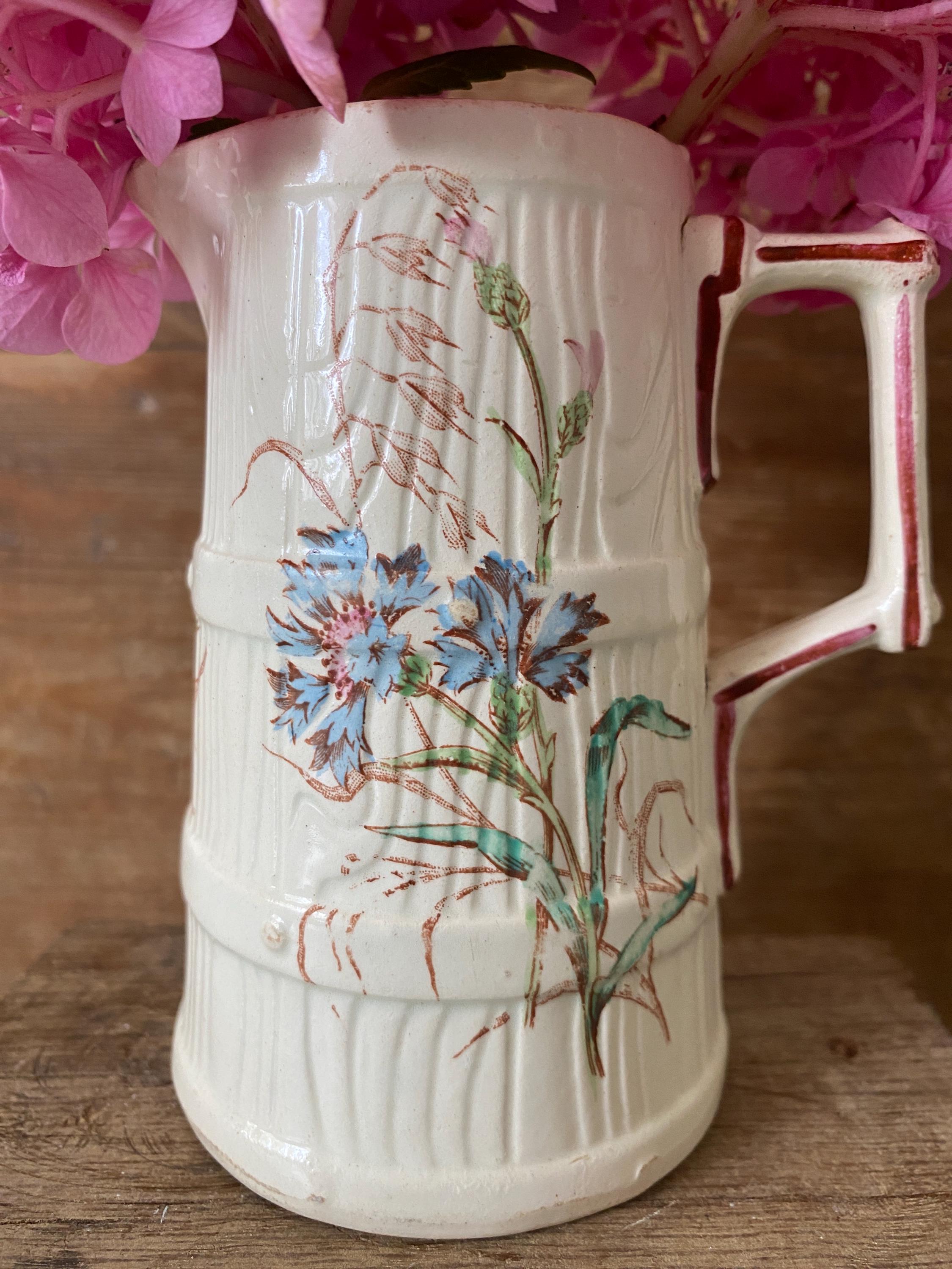 White ceramic pitcher with floral design 
