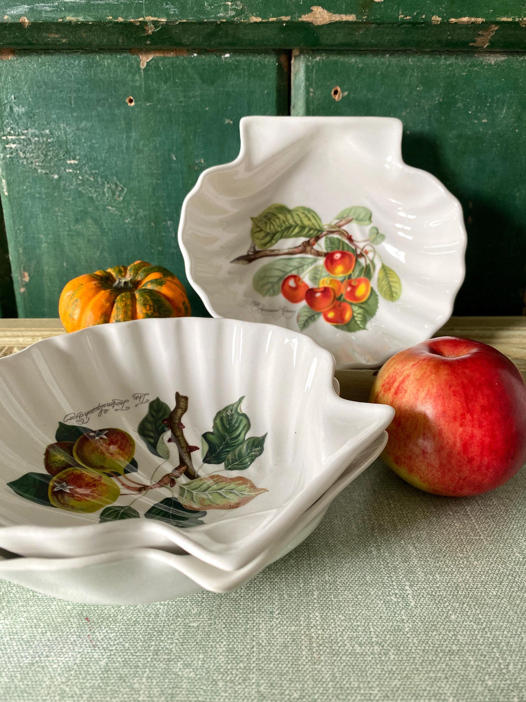 Three decorative ceramic plates with fruit designs