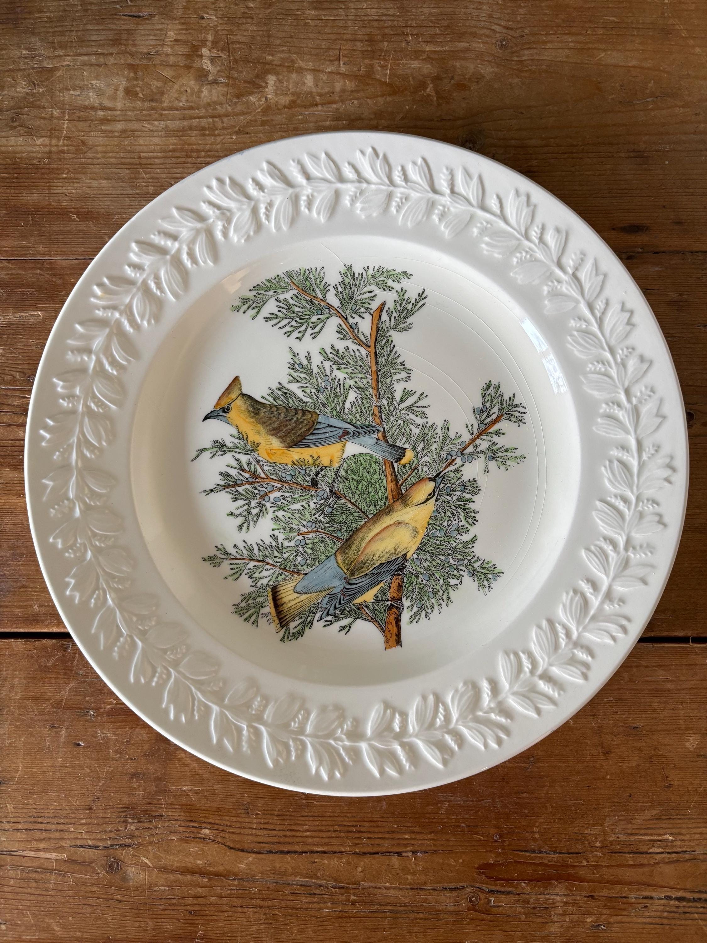 Decorative plate with bird and tree design and embossed leaf decoration