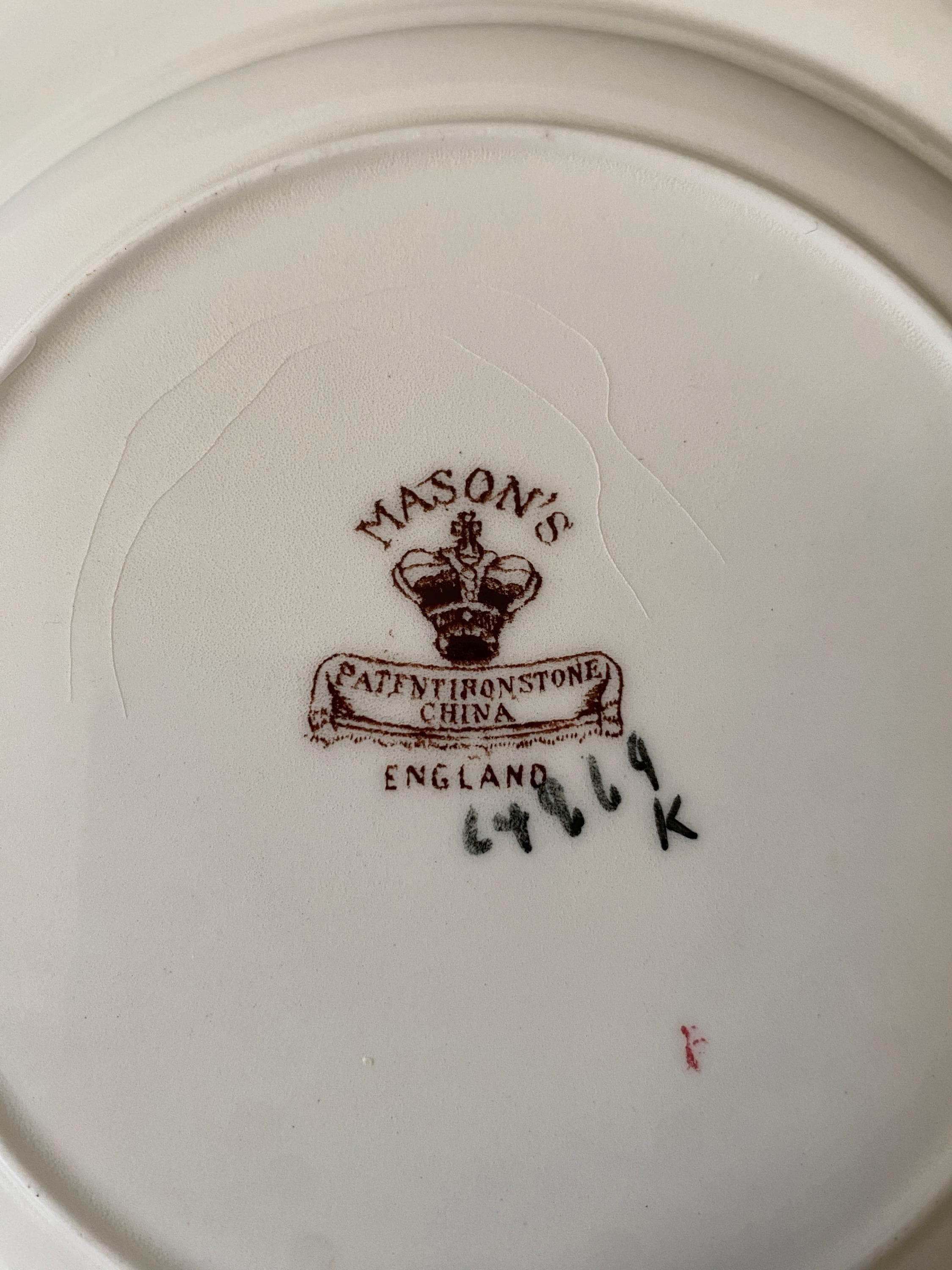 Mason's China Staffordshire logo on a white plate with a visible serial number.