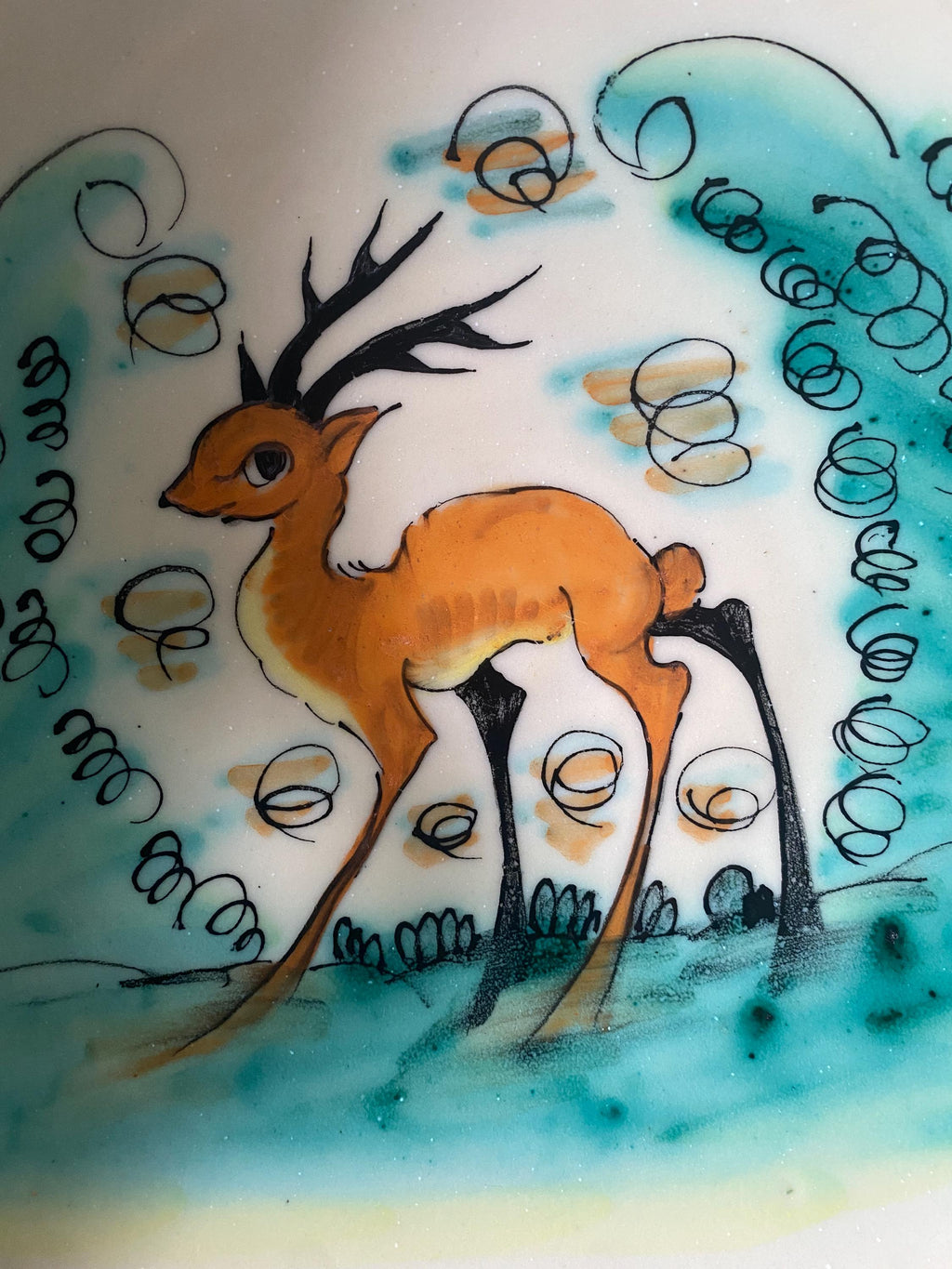 Decorative ceramic bowl close up with a deer illustration in a natural setting