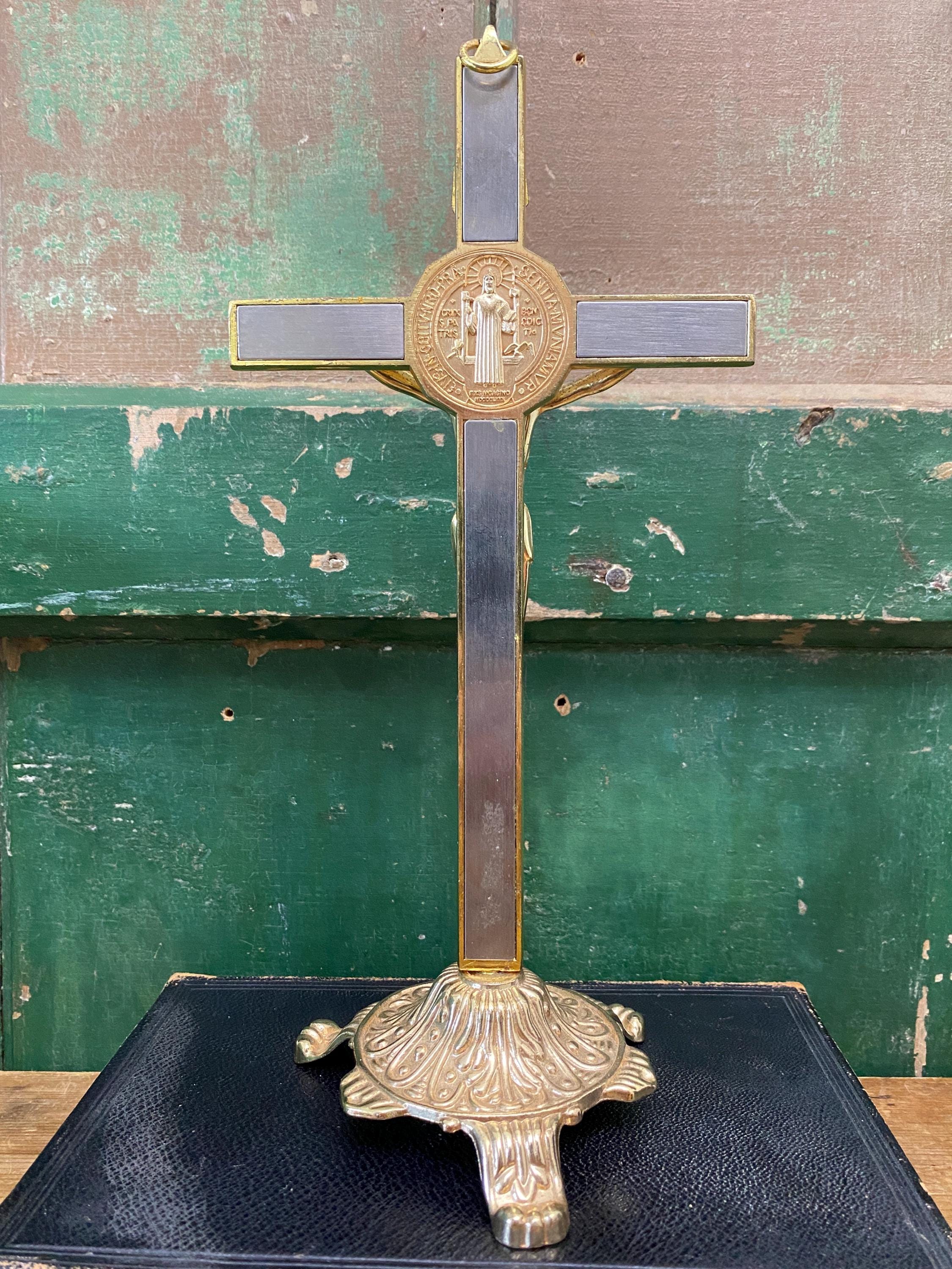 Gold and silver decorative cross with inset medallion on a stand