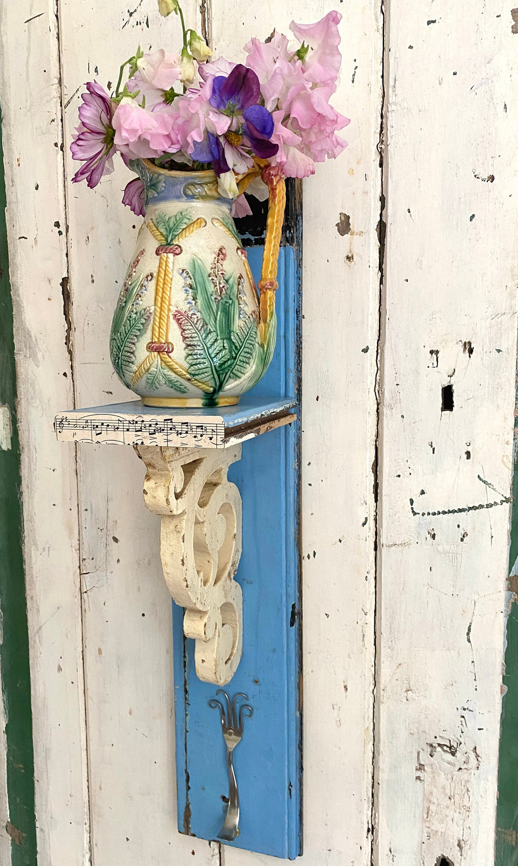 Rustic wooden shelf with decorative corbel and metal hook
