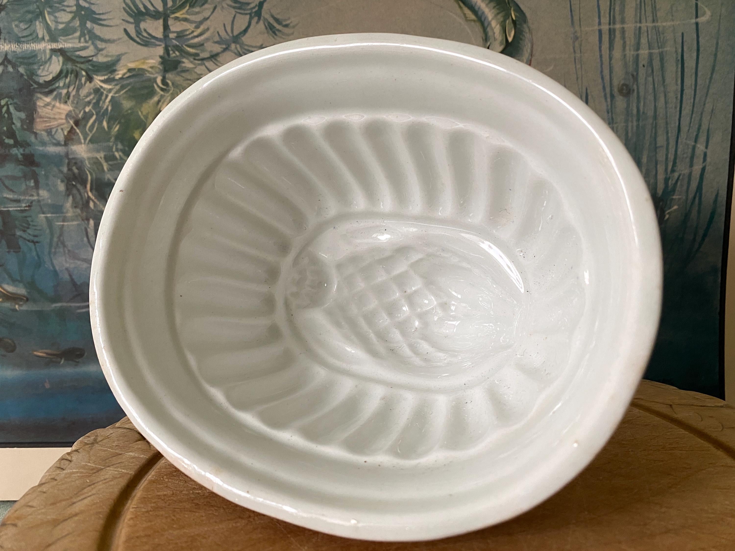 A white ceramic vintage jelly mould with thistle design