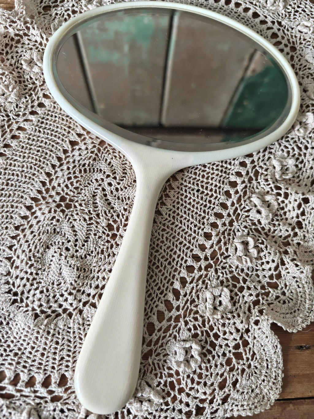 Handheld mirror on a lace doily