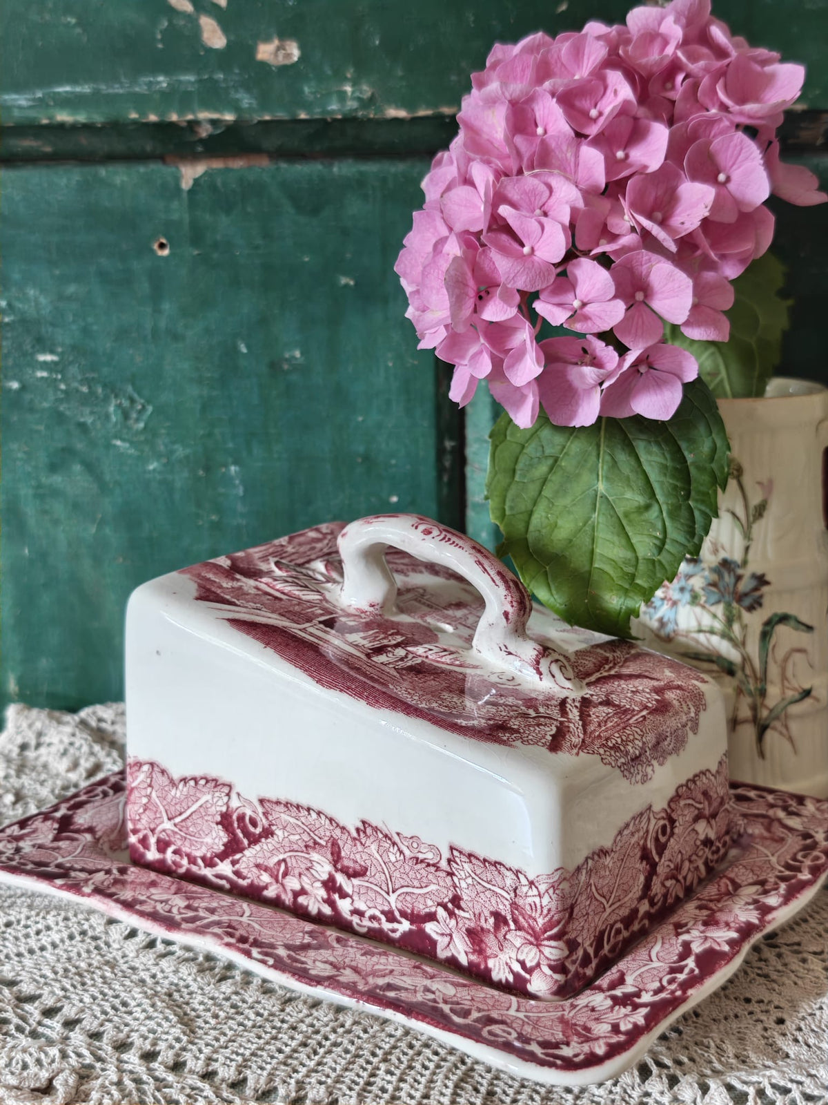 A Mason's ceramic butter dish with a pink toile pattern lid and base.
