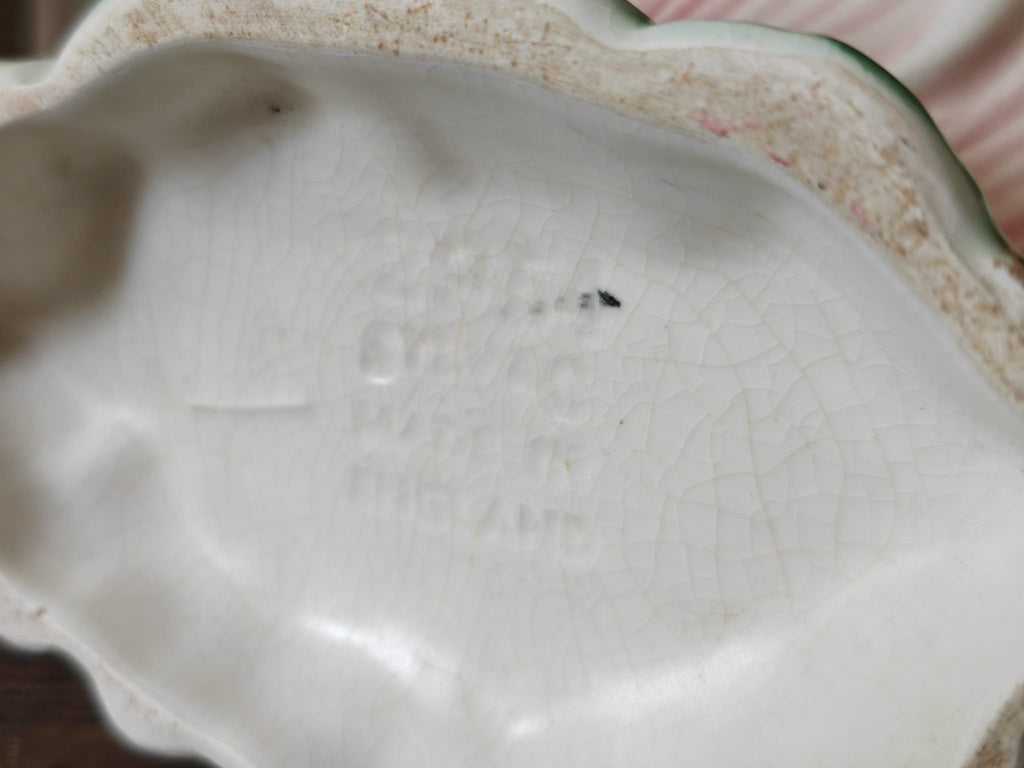 Close up of the base of a flower vase showing the makers mark.