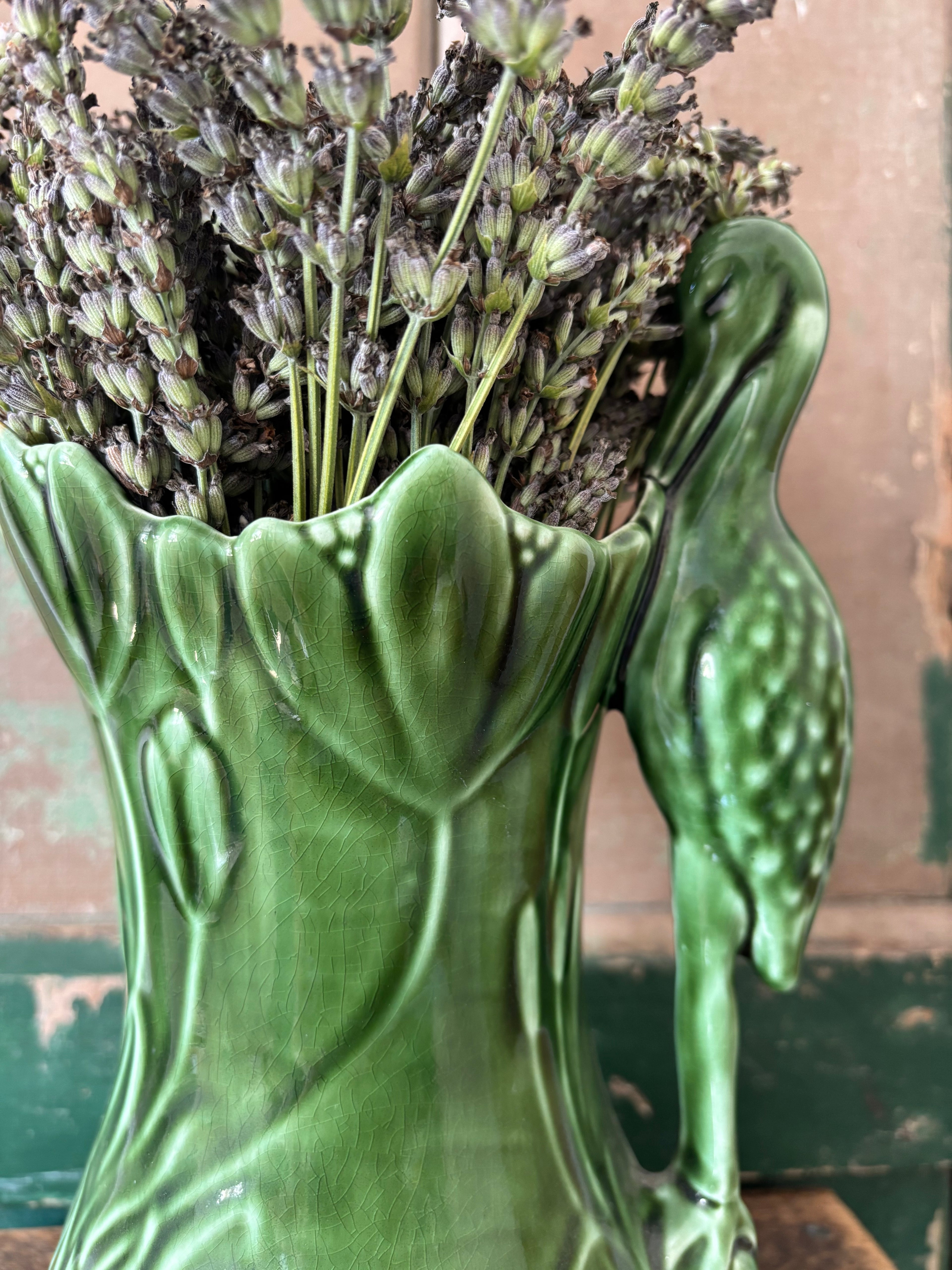 Close up of Sylvac Heron vase in green.