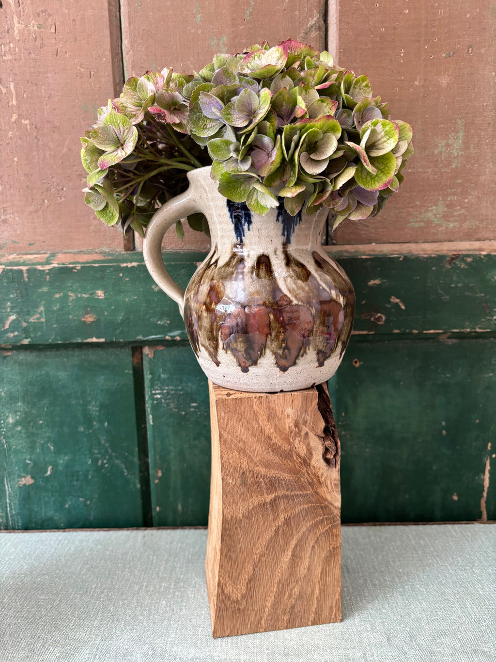 A rustic ceramic pitcher vase.