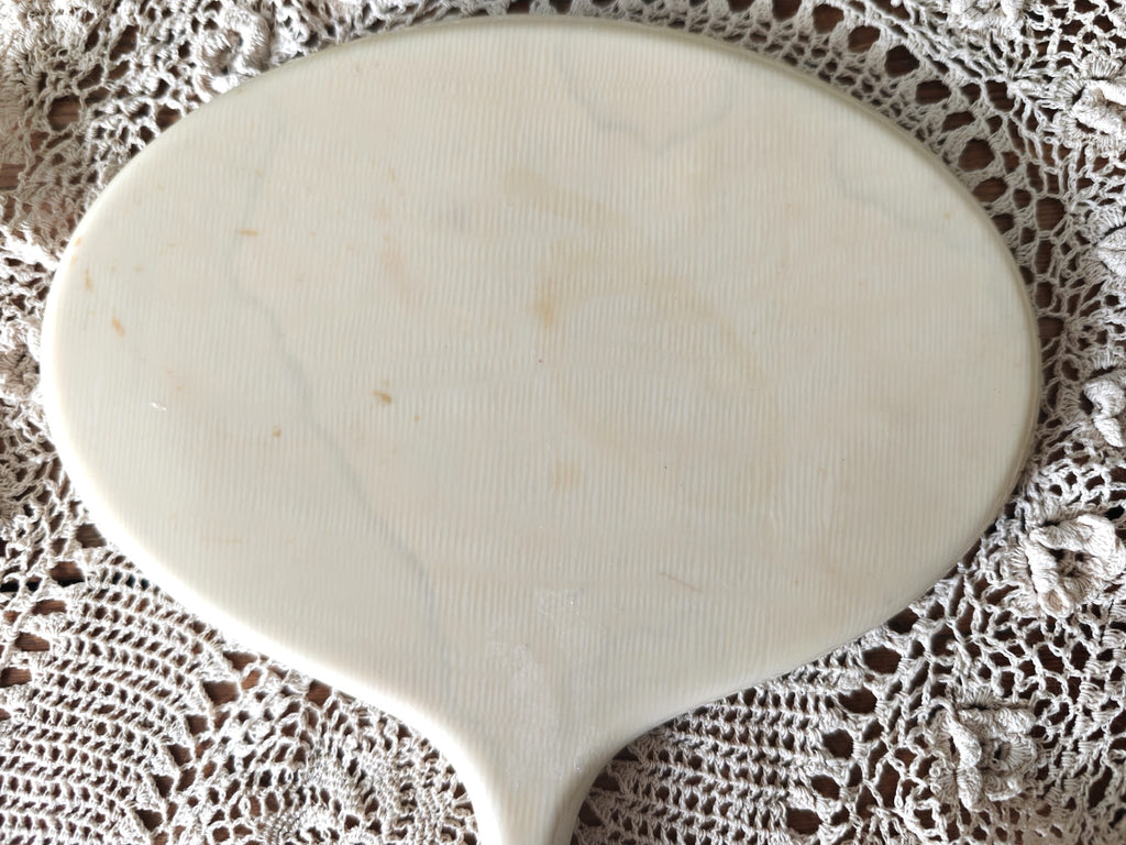 back of vintage hand mirror