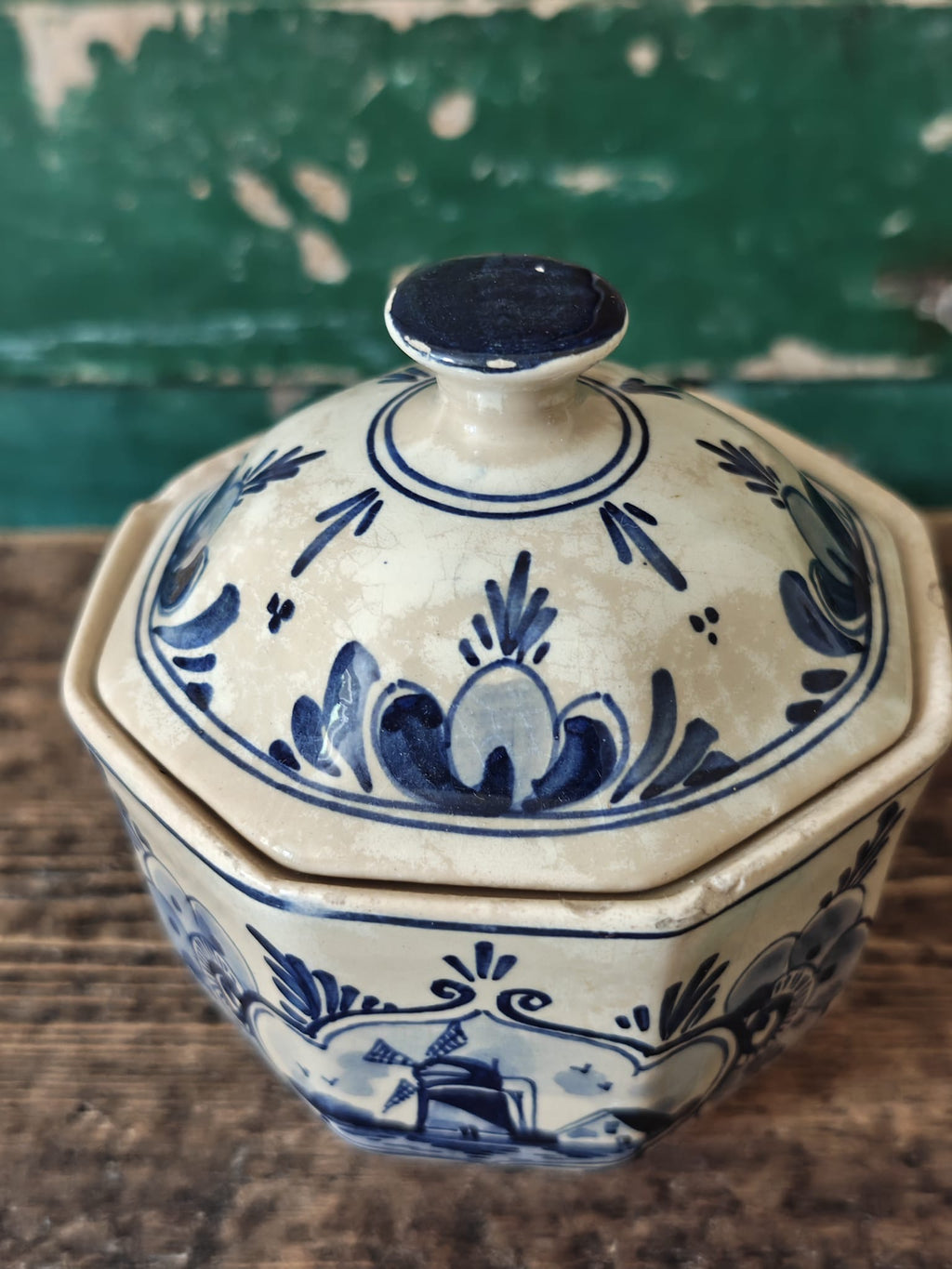 A vintage blue and white hand-painted stoneware lidded sugar bowl.
