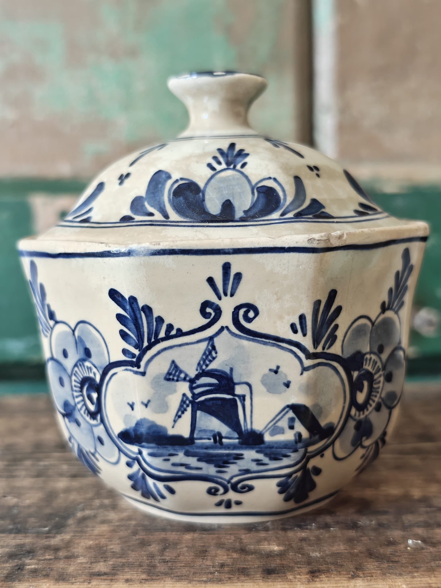 A vintage blue and white hand-painted stoneware lidded sugar bowl.
