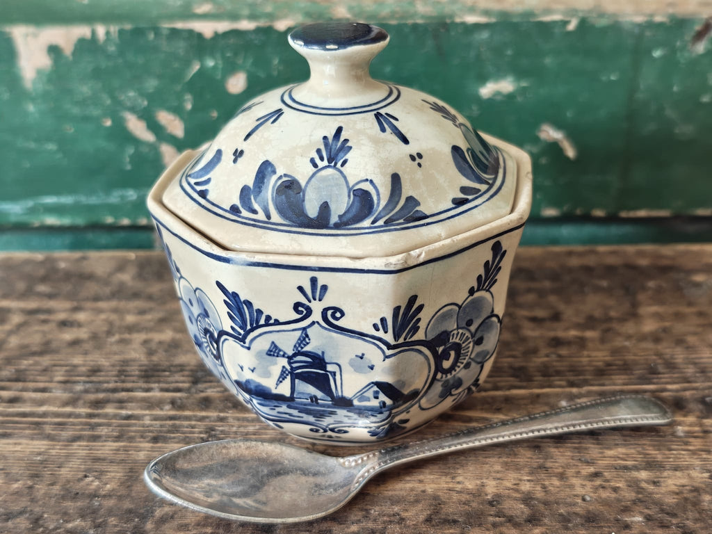 A vintage blue and white hand-painted stoneware lidded sugar bowl.