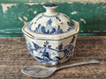 A vintage blue and white hand-painted stoneware lidded sugar bowl.