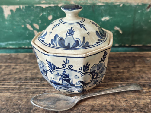 A vintage blue and white hand-painted stoneware lidded sugar bowl.