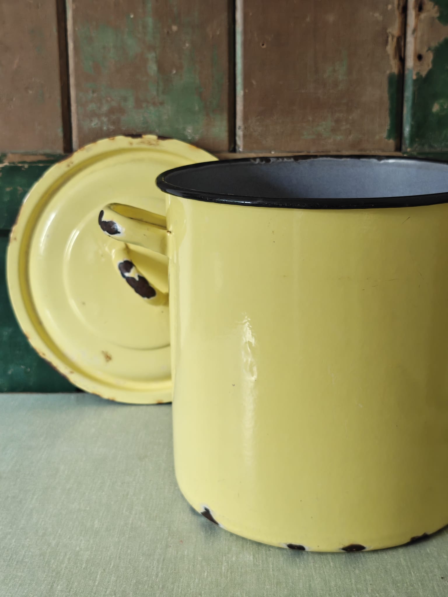 Yellow enamel pot with blue interior.