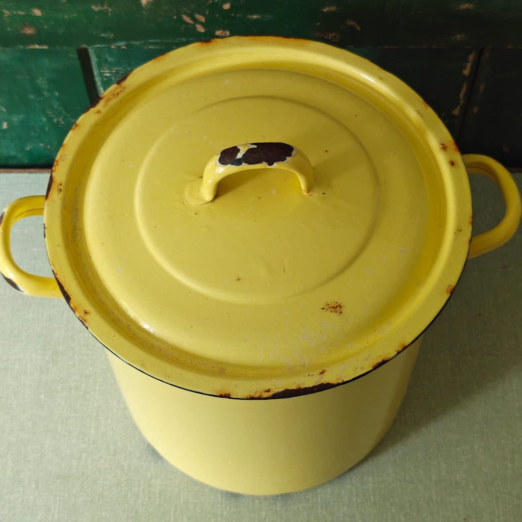 Yellow enameled pot with a lid.