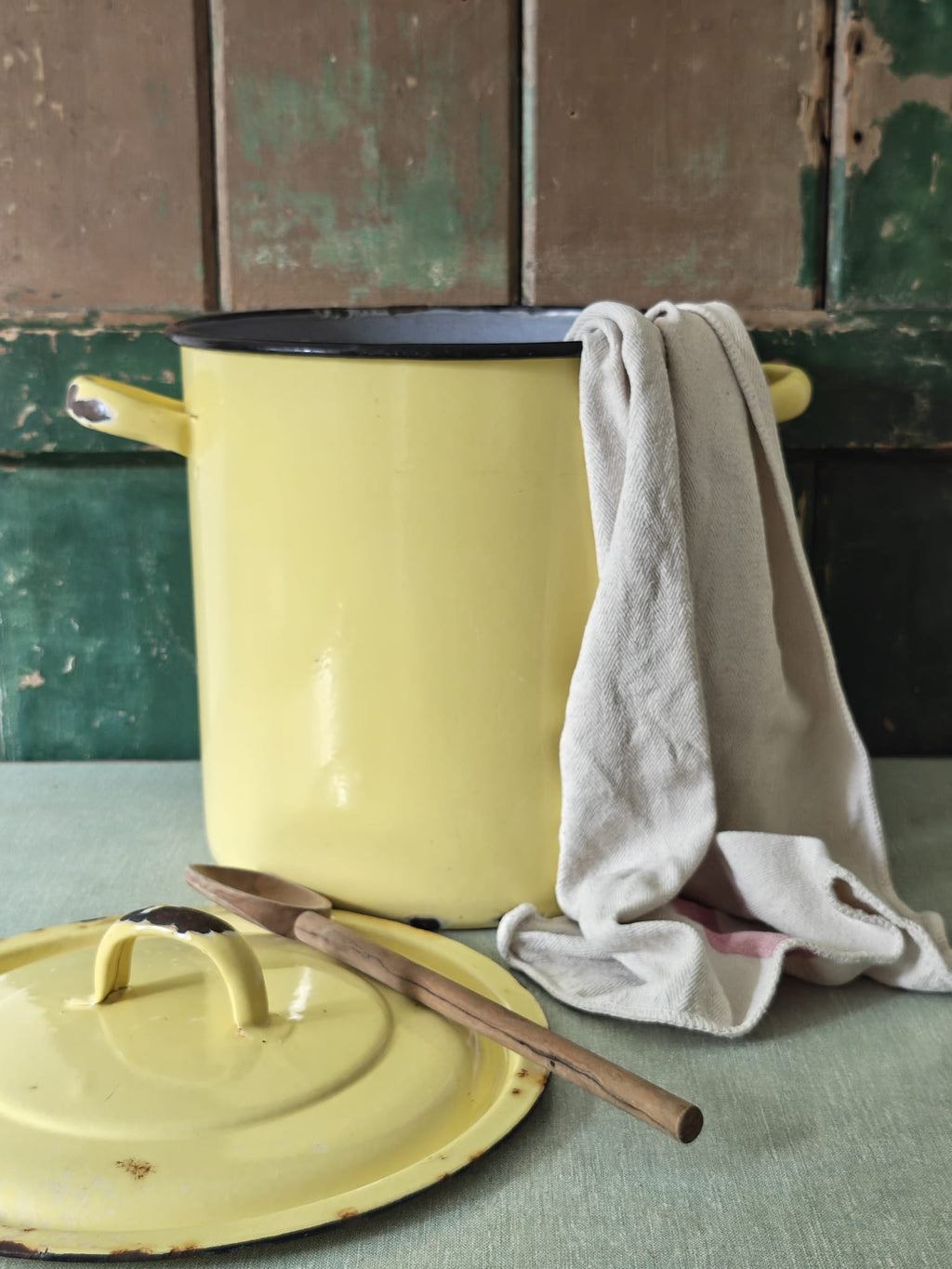 Yellow enameled pot with a lid 