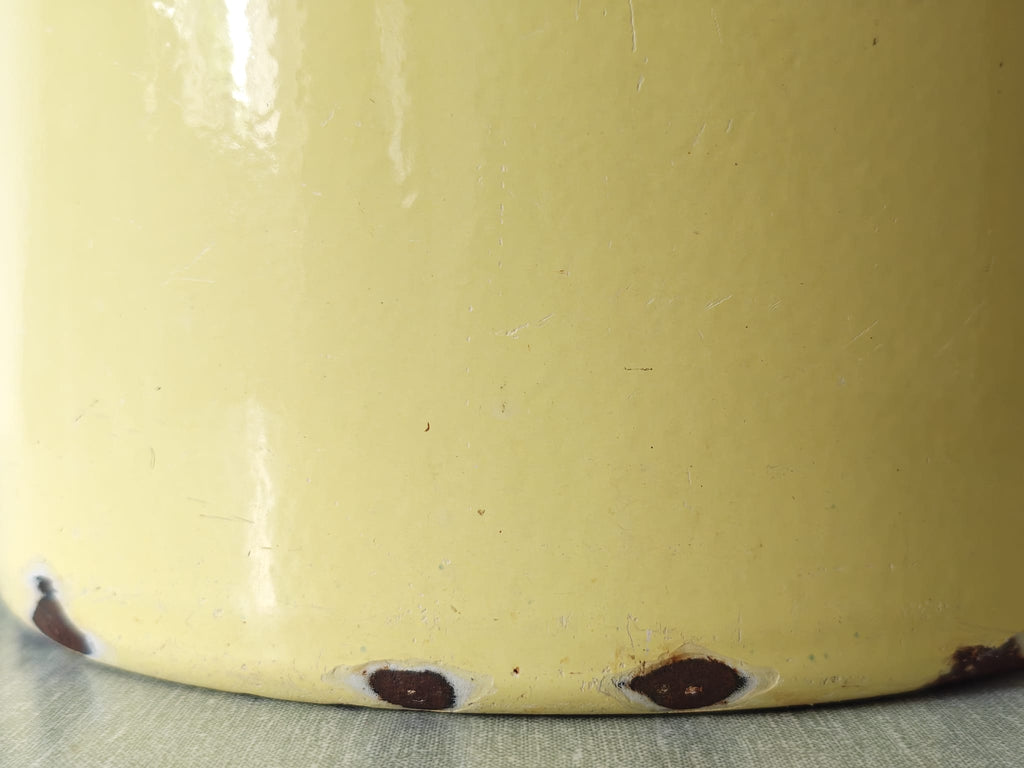 Close-up of a  yellow enamel pot.