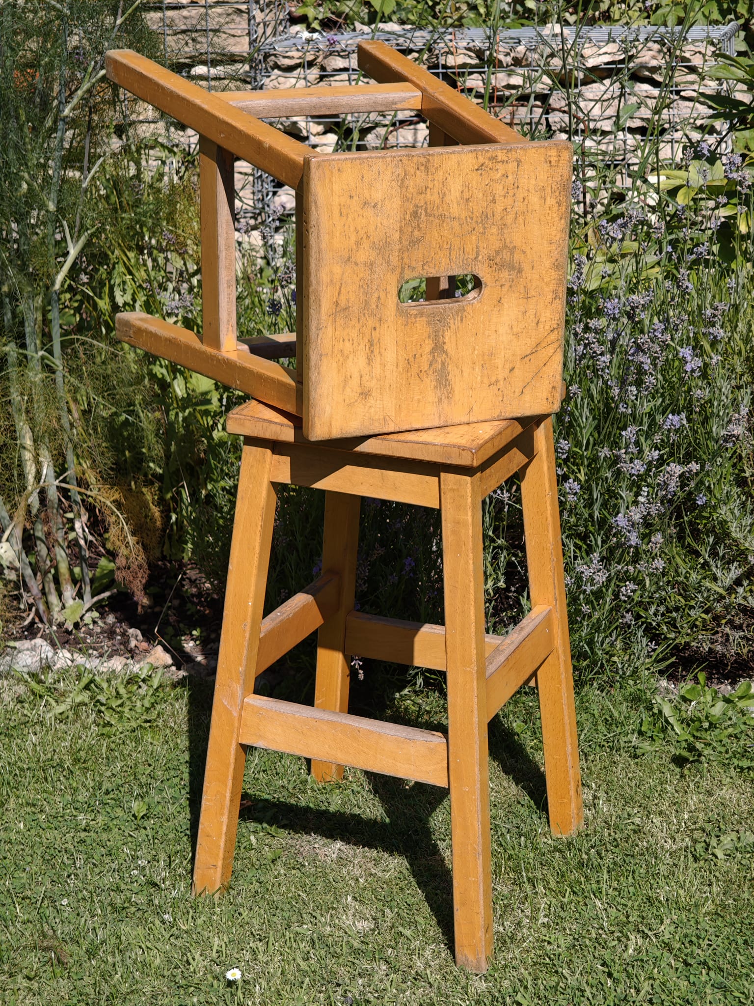 two rustic light brown wooden stools