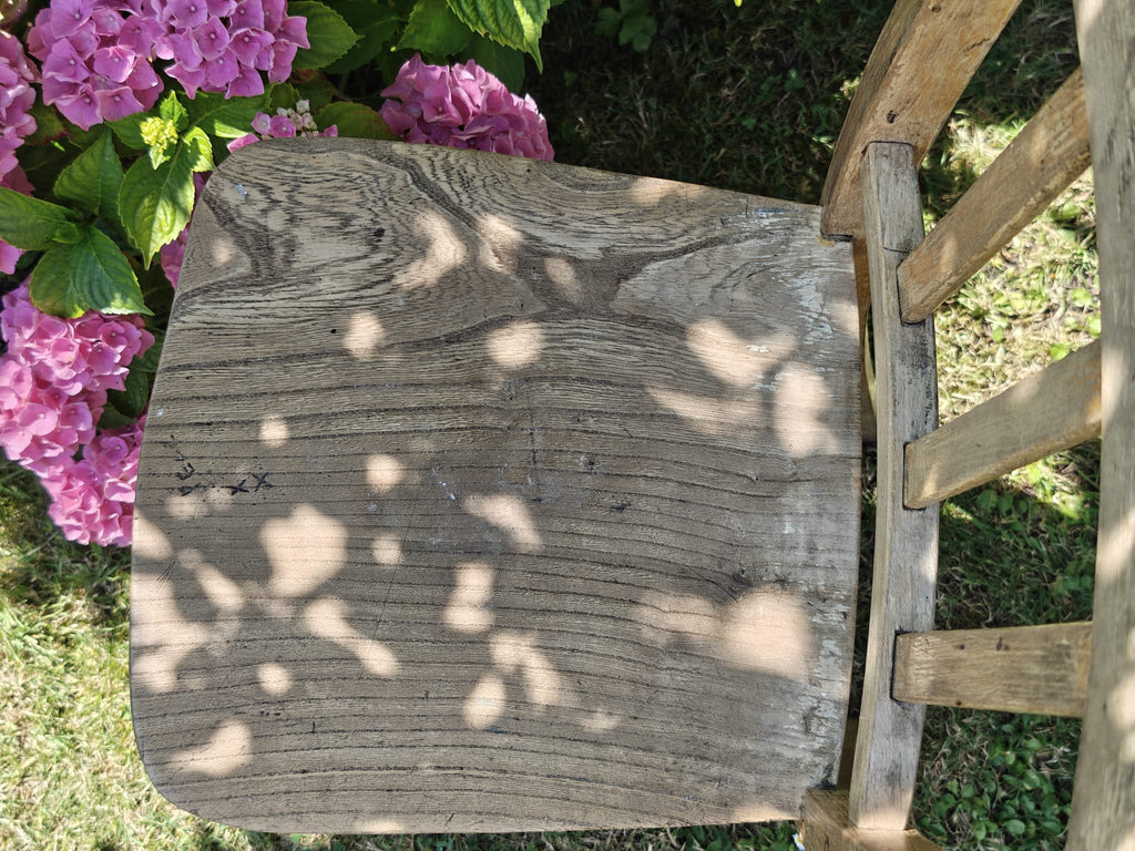 A rustic wooden chair seat viewed from above