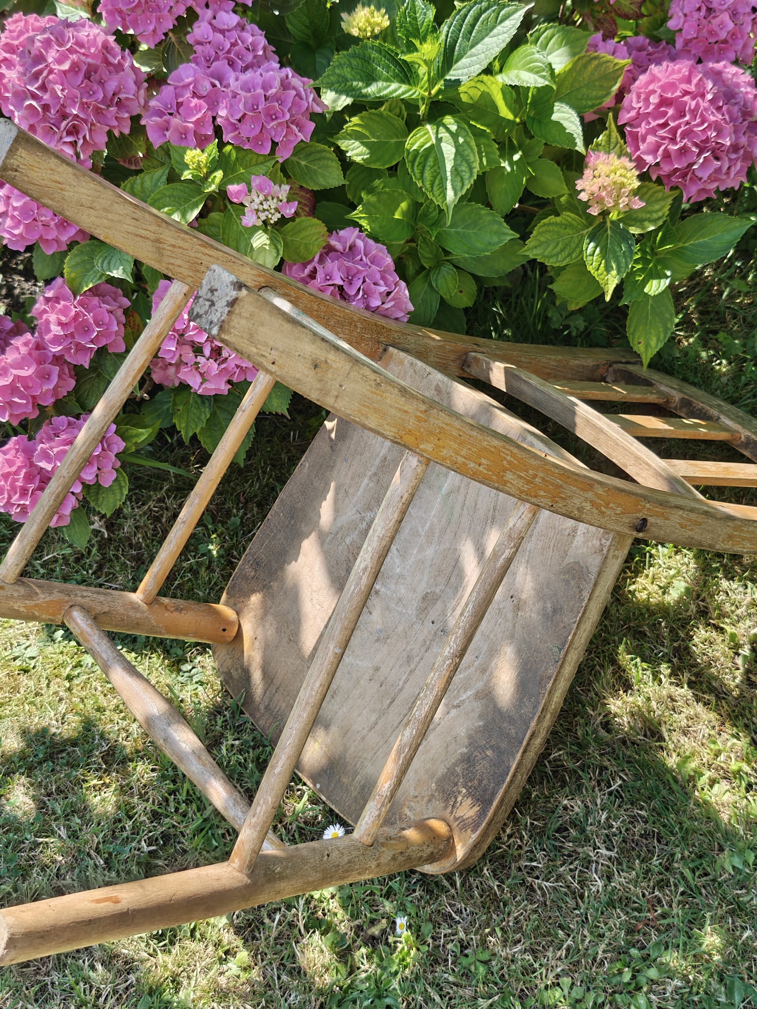 A rustic wooden chair with a weathered finish 