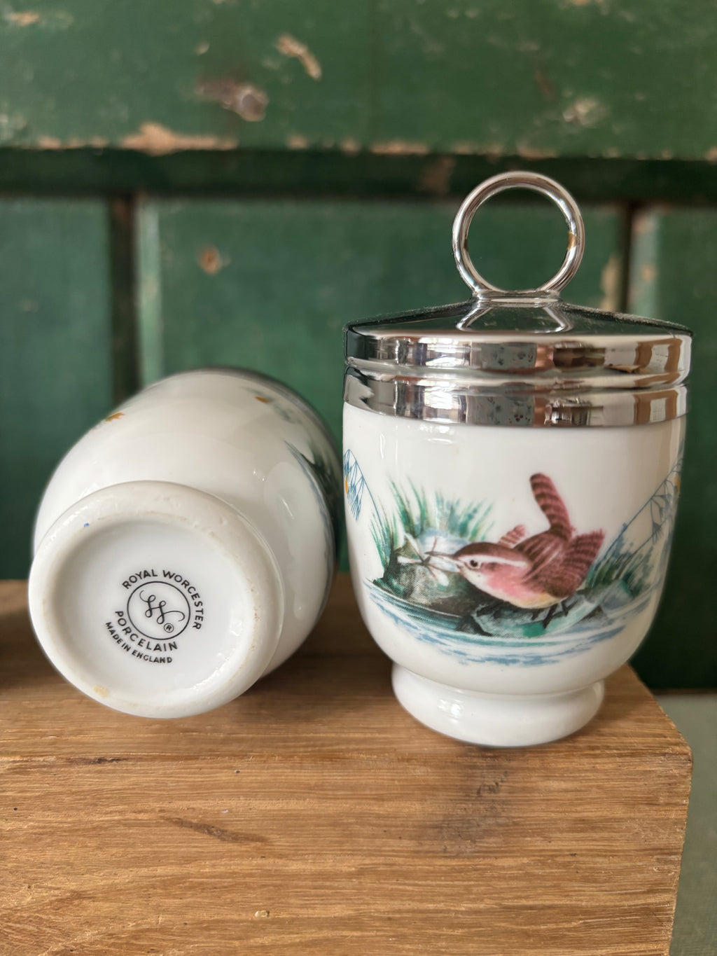 Two egg coddlers with one showing the maker's mark underneath.