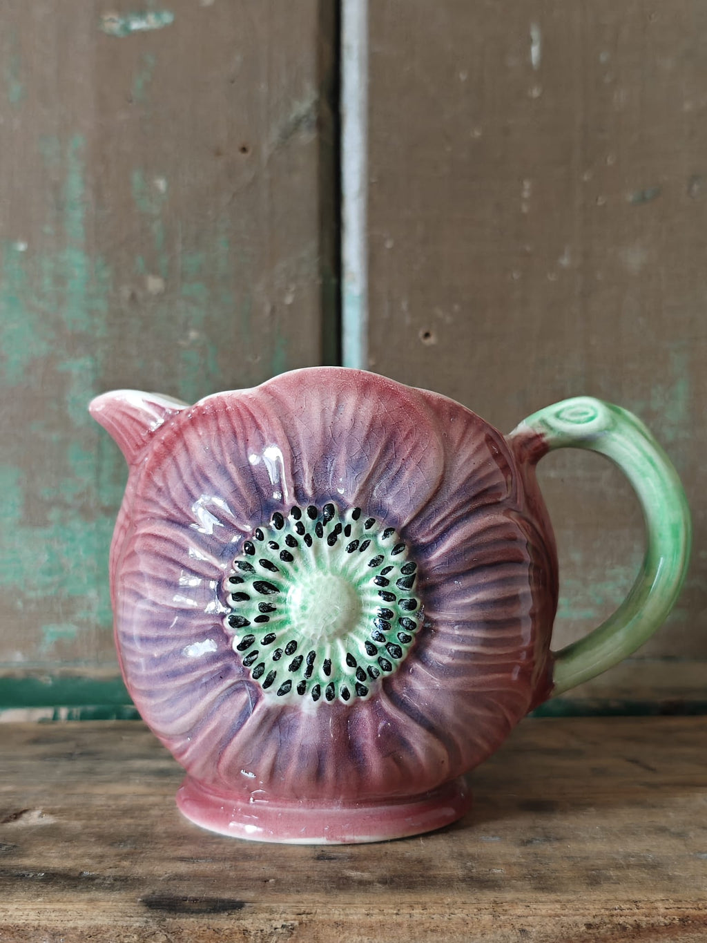 A vintage ceramic flower-shaped jug