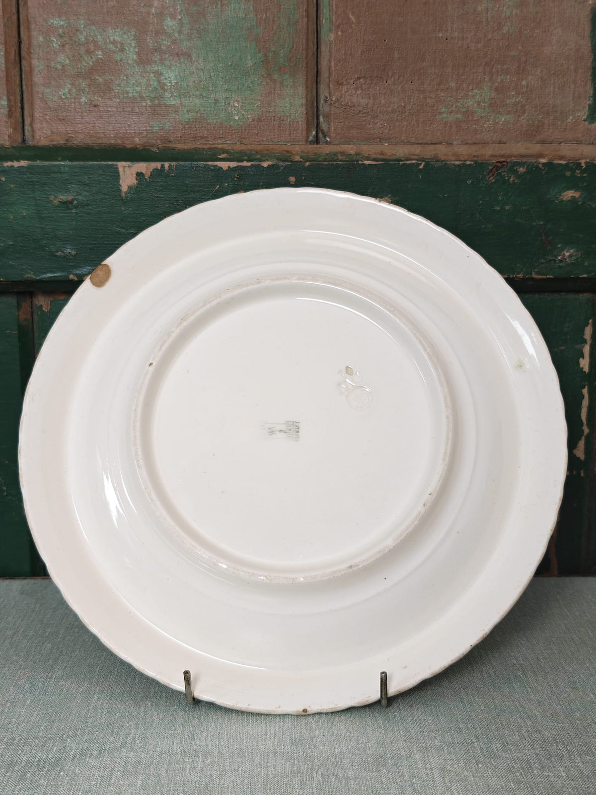 A white ceramic plate shown from the back.