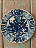 Ceramic plate with blue and white stylised floral pattern
