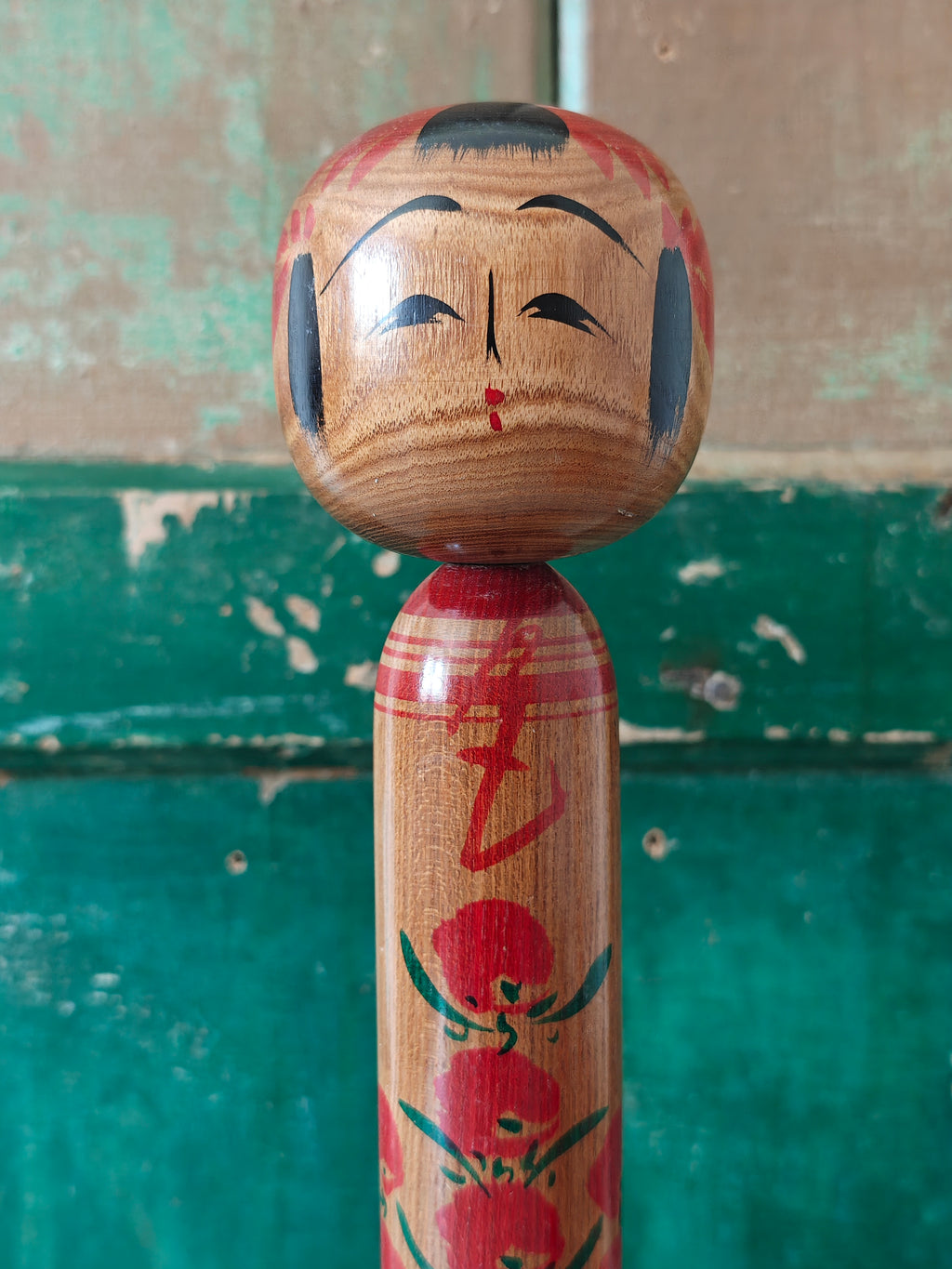 Wooden kokeshi doll with hand painted decoration