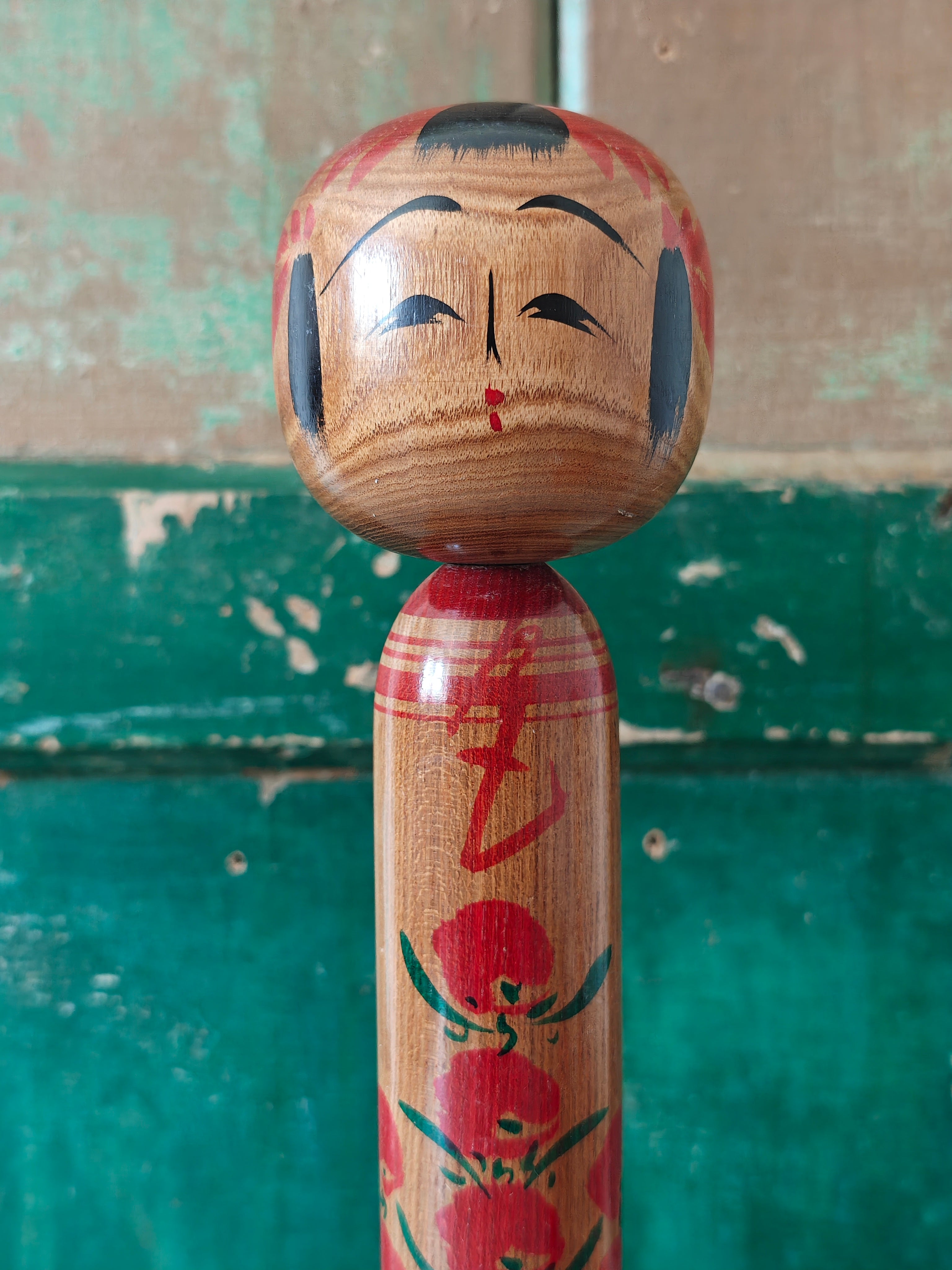 Wooden kokeshi doll with hand painted decoration