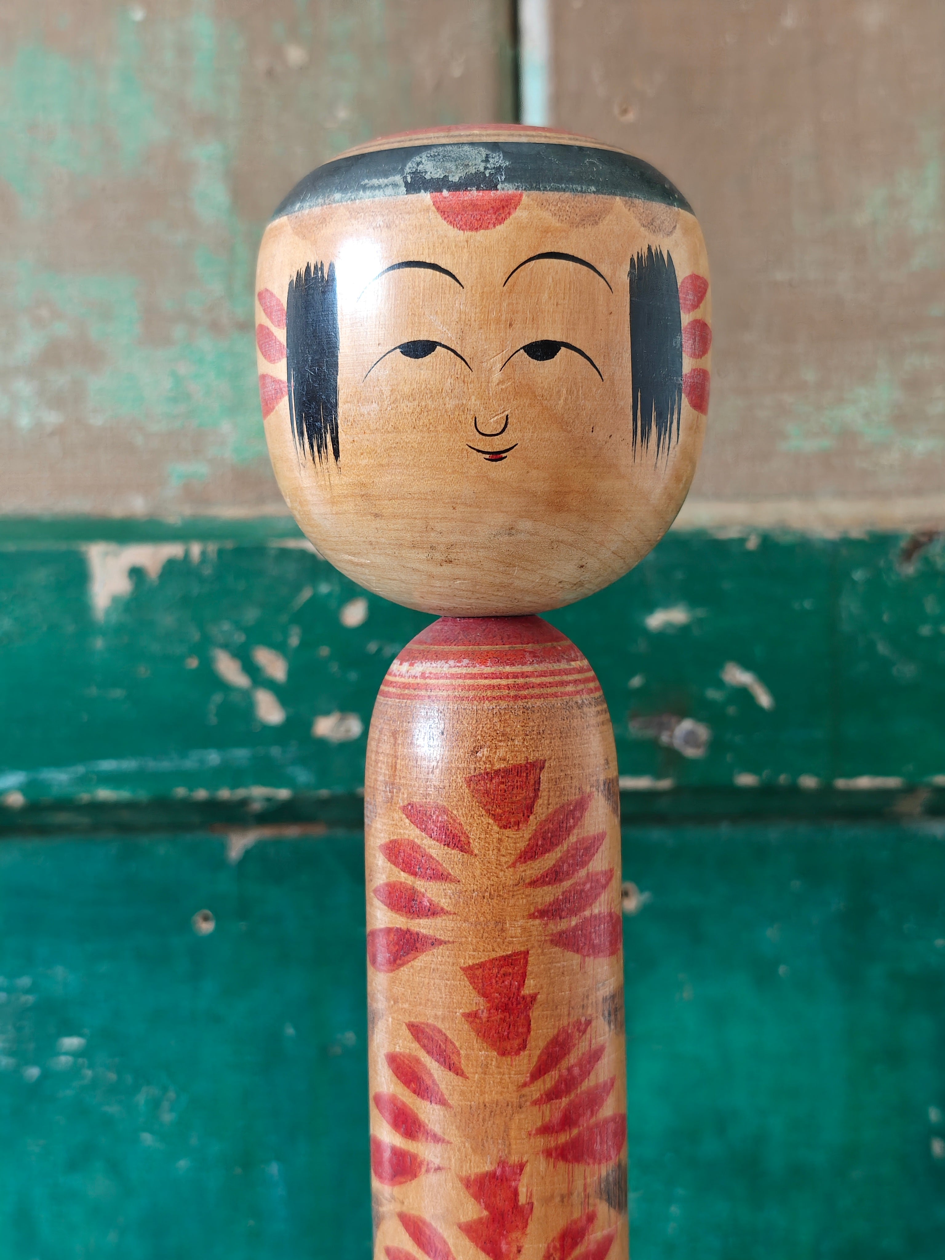 Wooden kokeshi doll with traditional design 