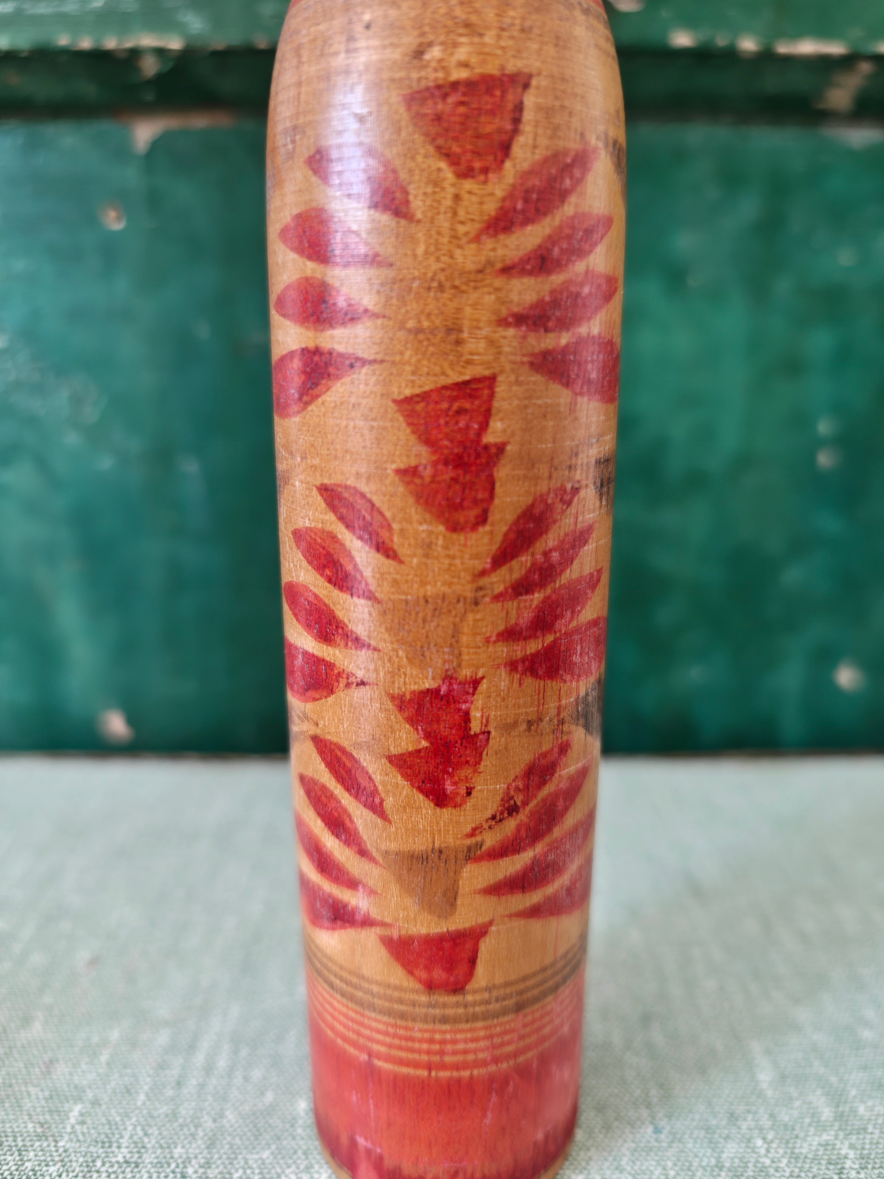 Hand painted red flower decoration on wooden figure