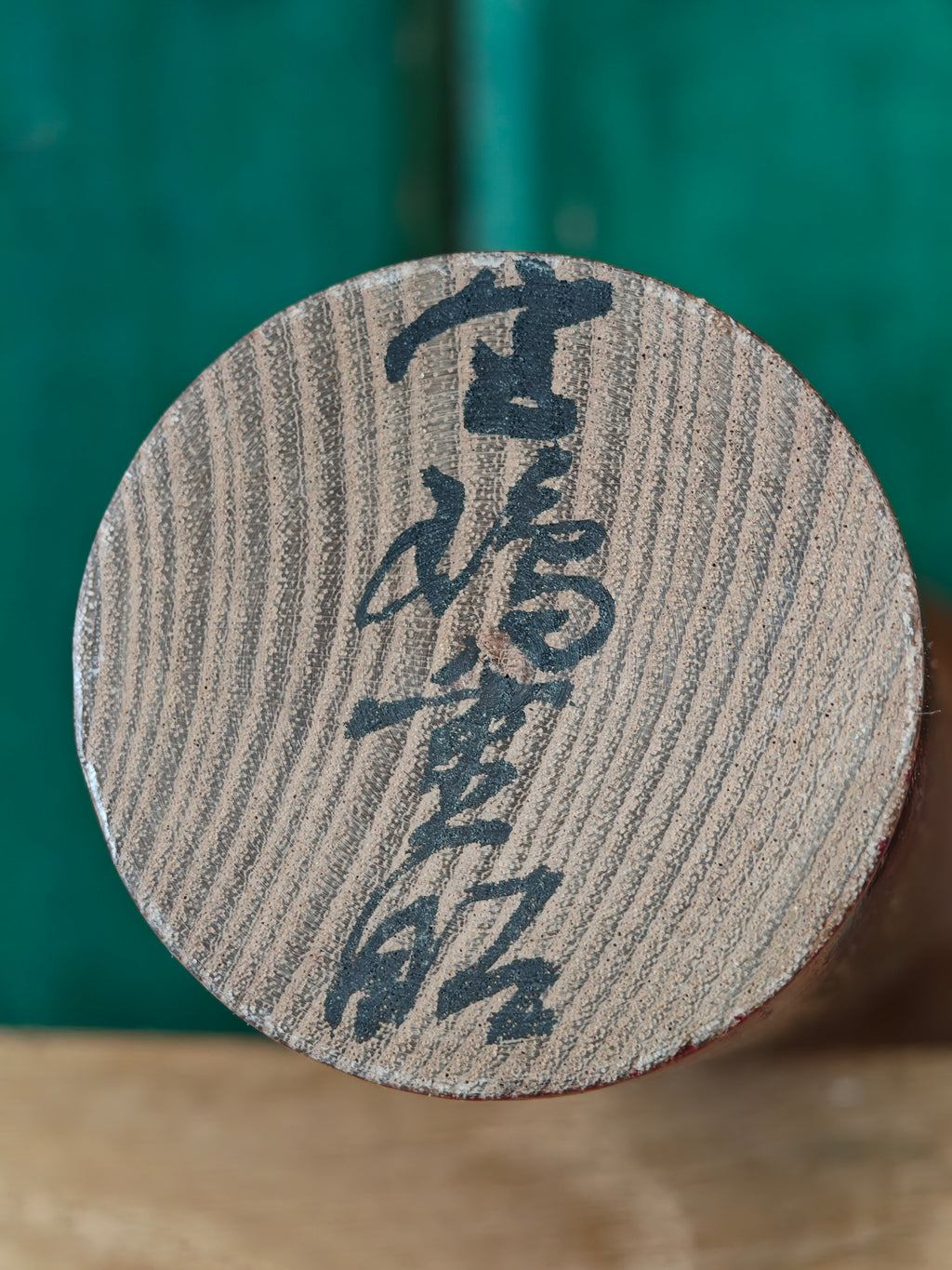 Japanese artist's signature on base of wooden figure
