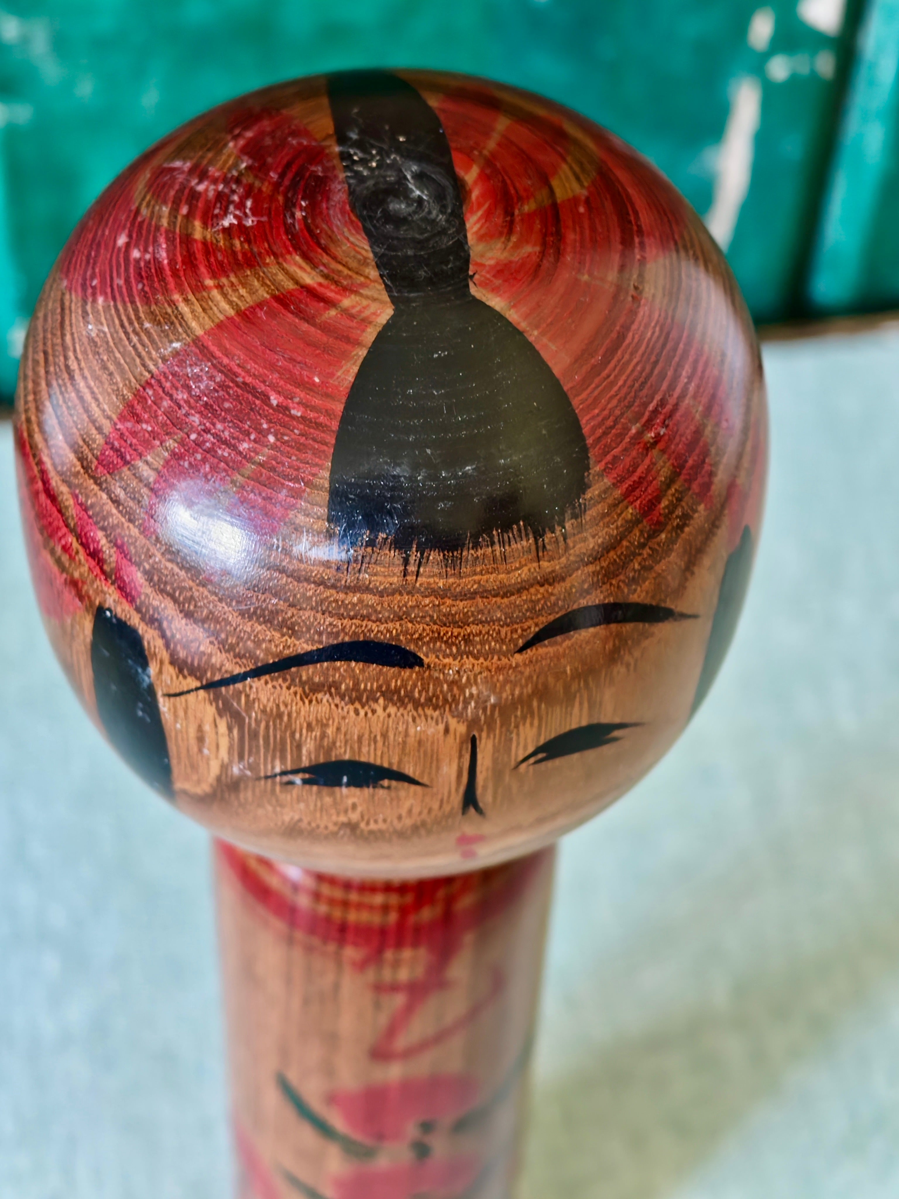 Close-up view of a wooden kokeshi doll showing top of head