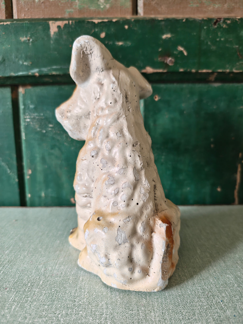 Back view of a plaster sculpture of a terrier dog
