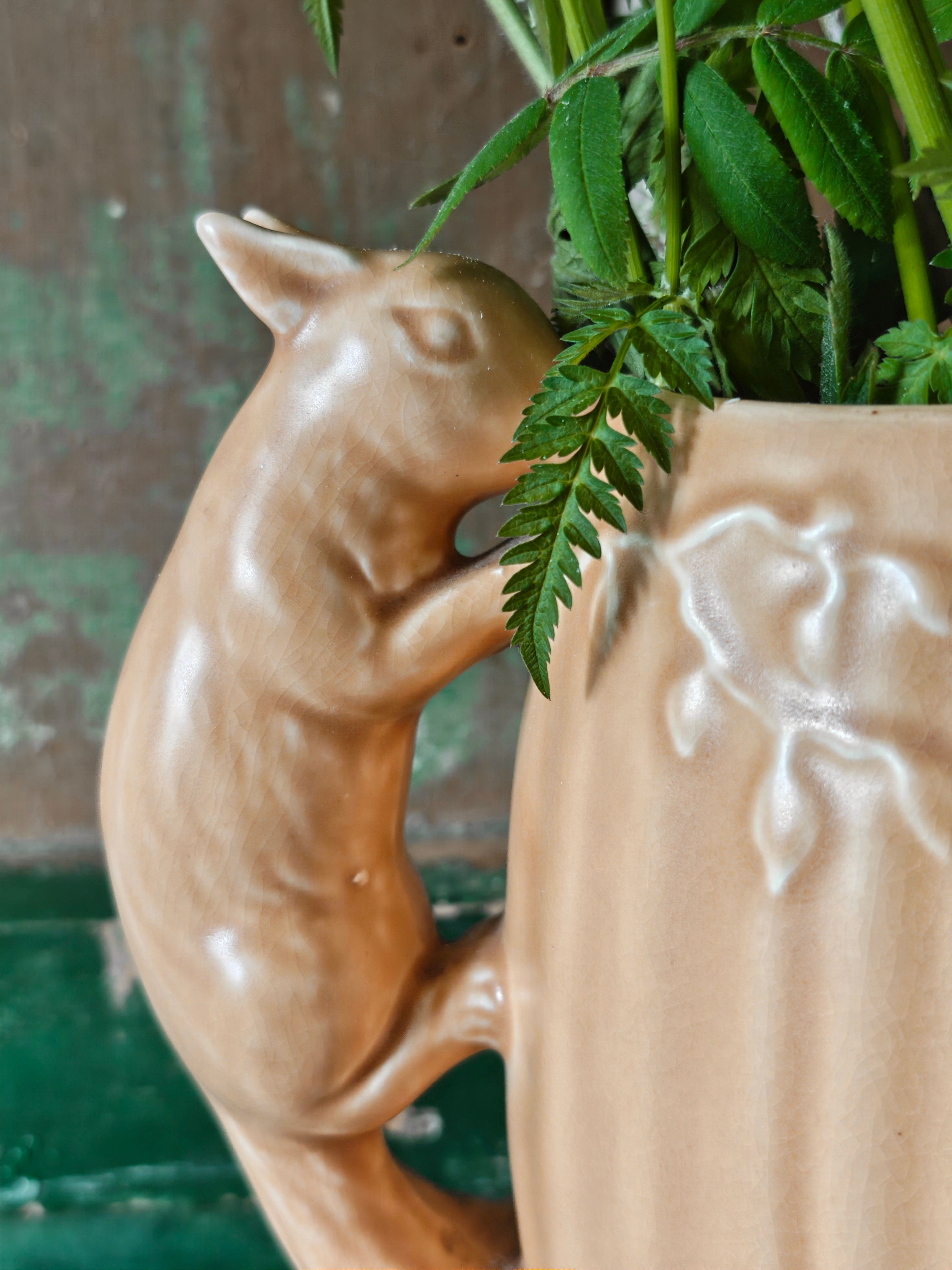Close-up of squirrel shaped handle on a ceramic vase