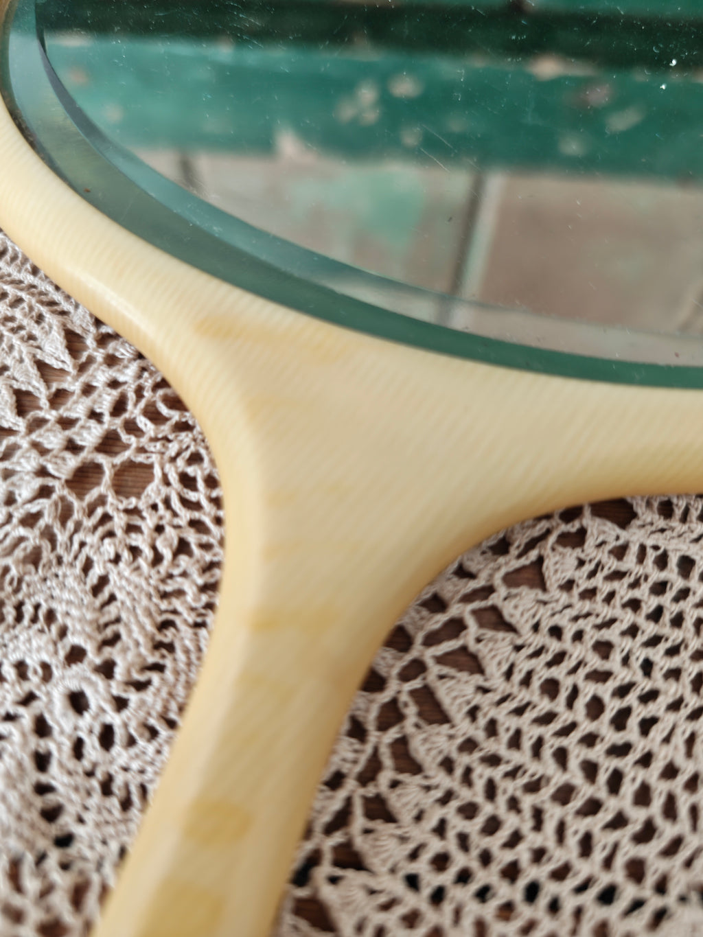 Close-up of a vintage ivory coloured oval hand mirror