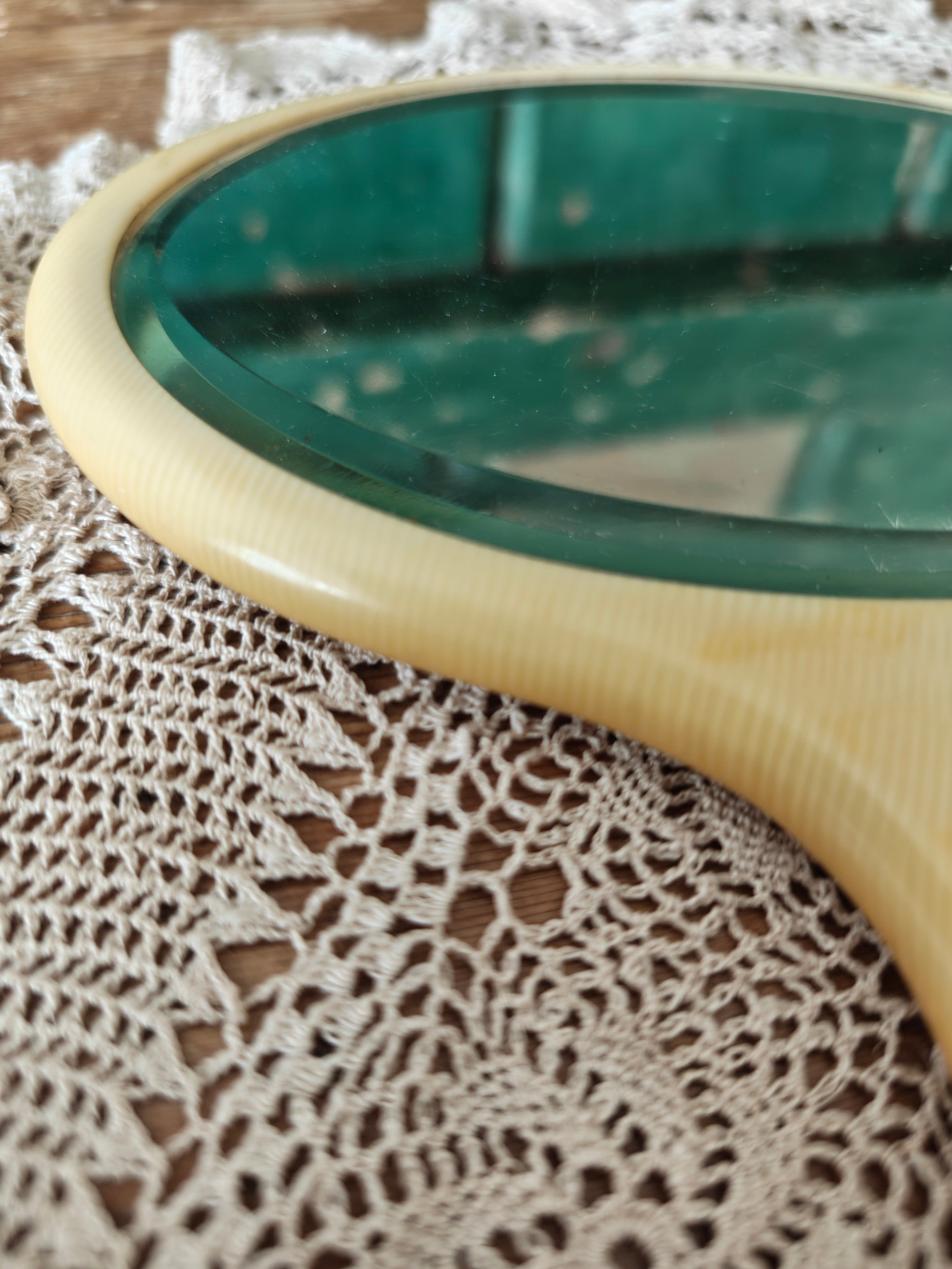 Close-up of a vintage ivory coloured oval hand mirror