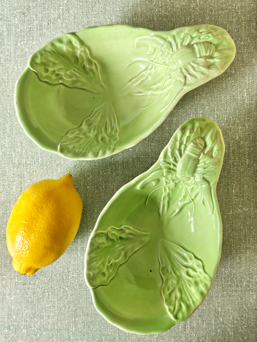 Two green ceramic dishes with lobster design