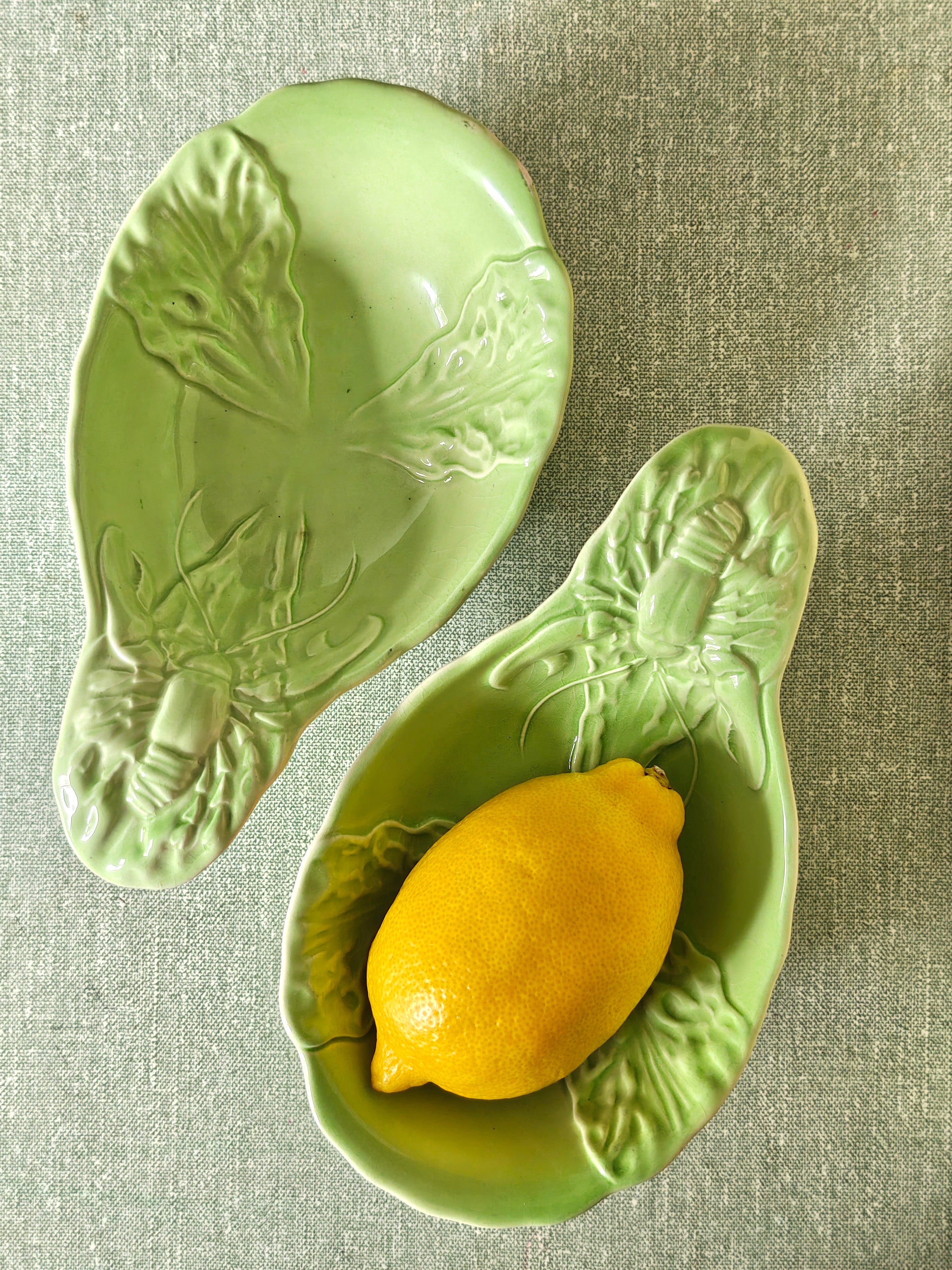 Two green ceramic dishes with lobster design