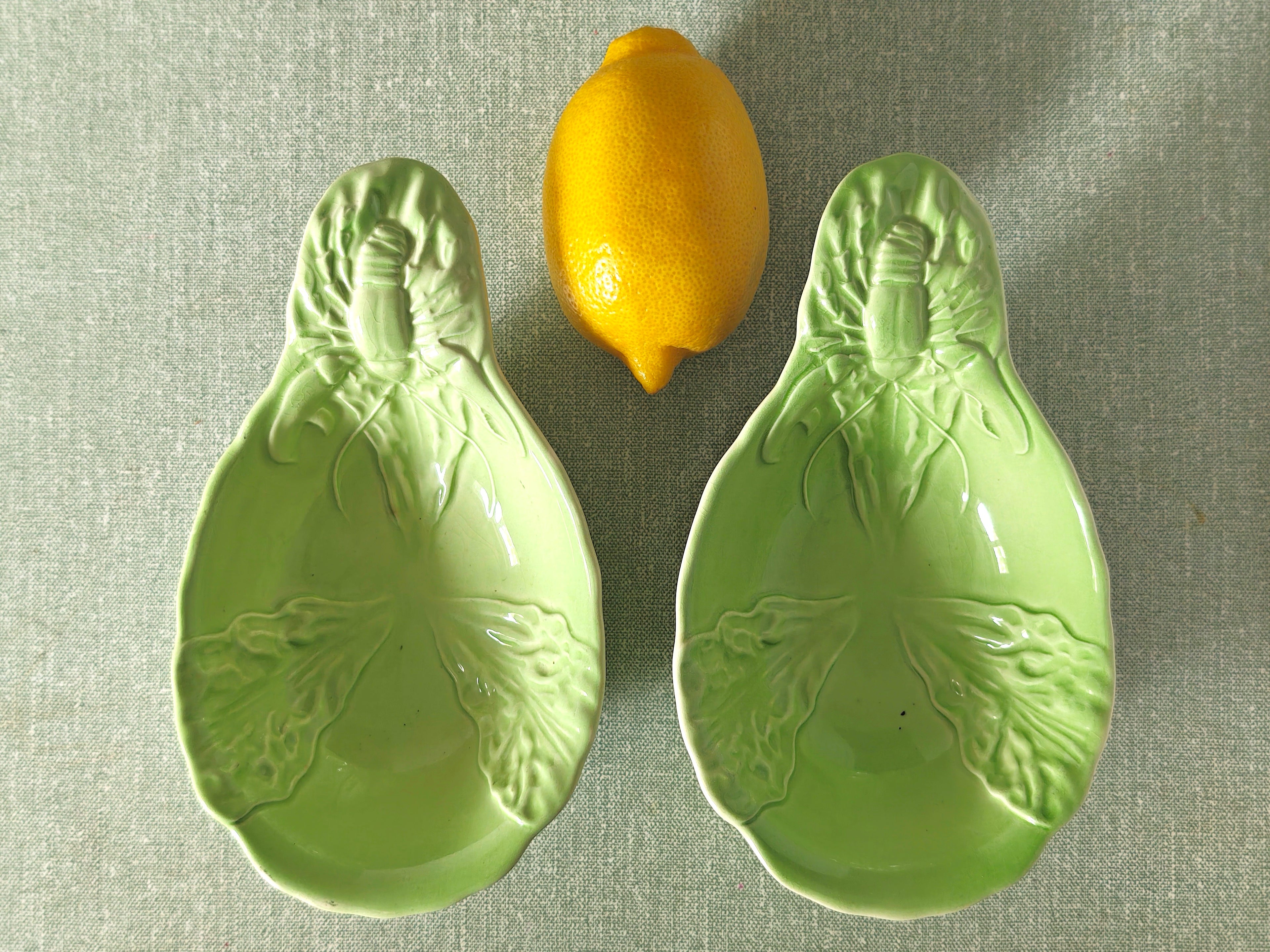 two green ceramic dishes with lobster design