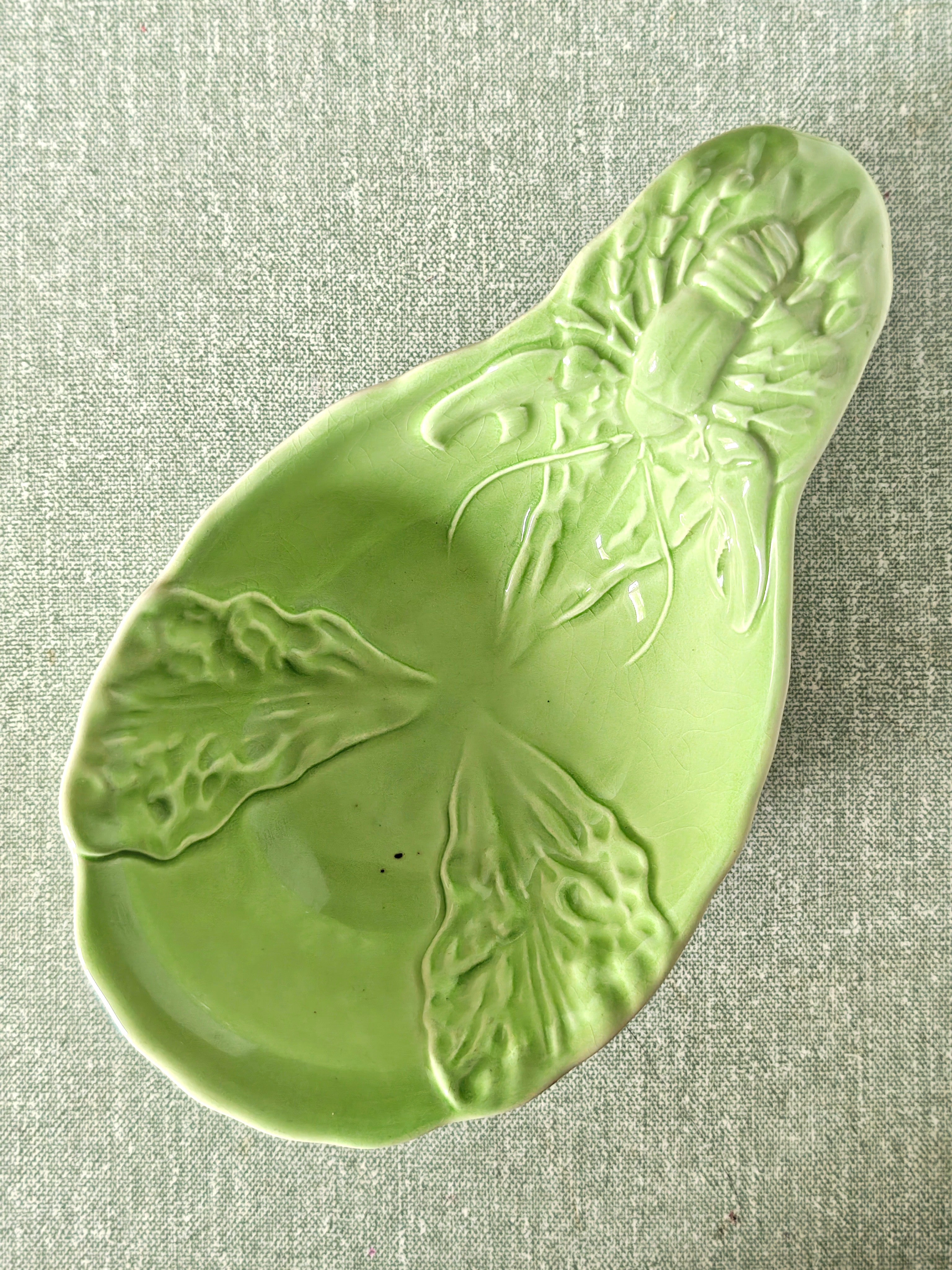 Green ceramic dish showing lobster and leaf pattern