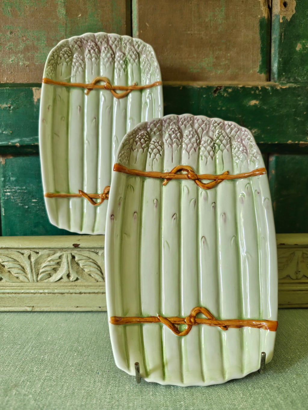 Two decorative green ceramic asparagus platters