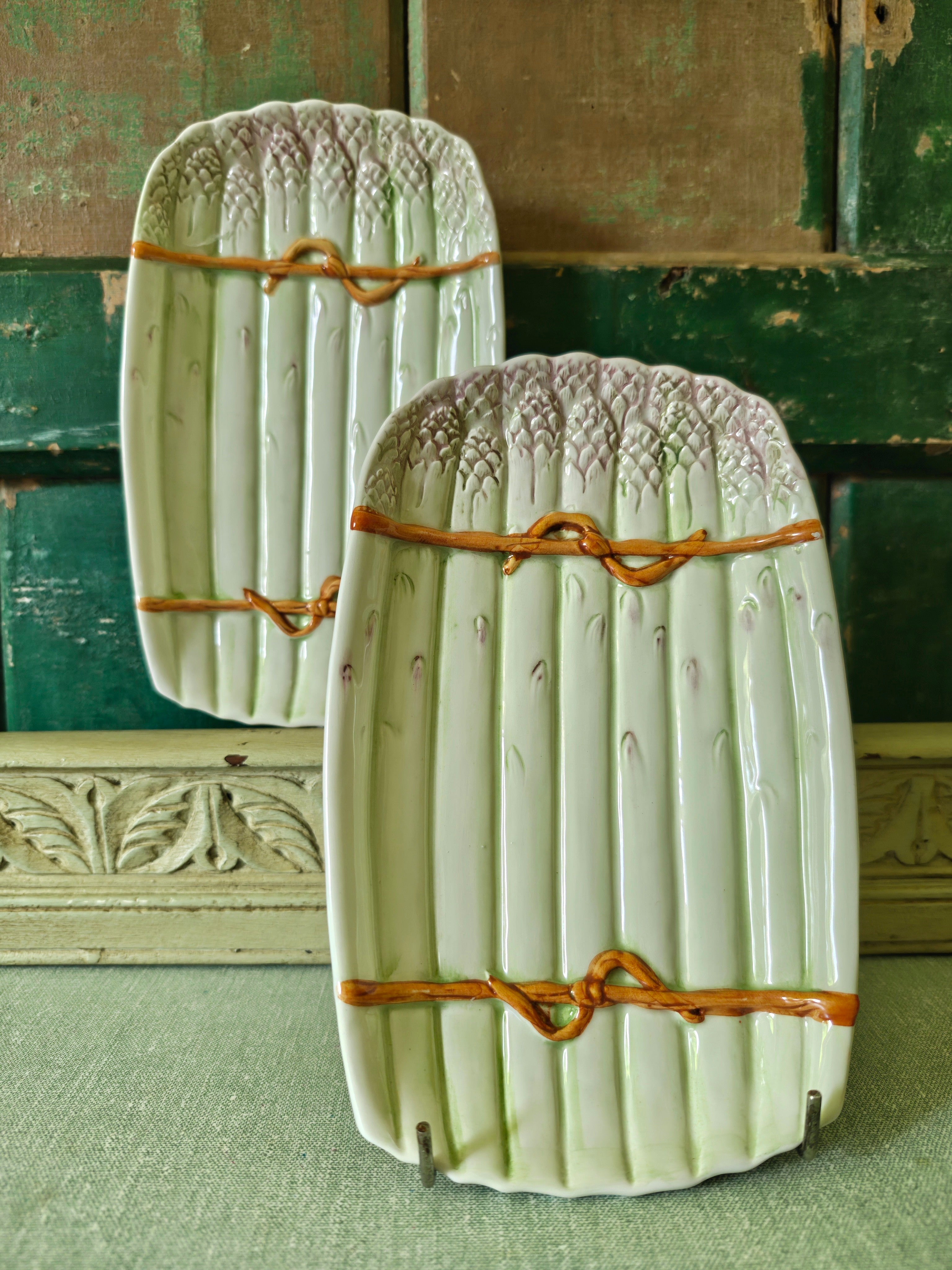 Two decorative green ceramic asparagus platters
