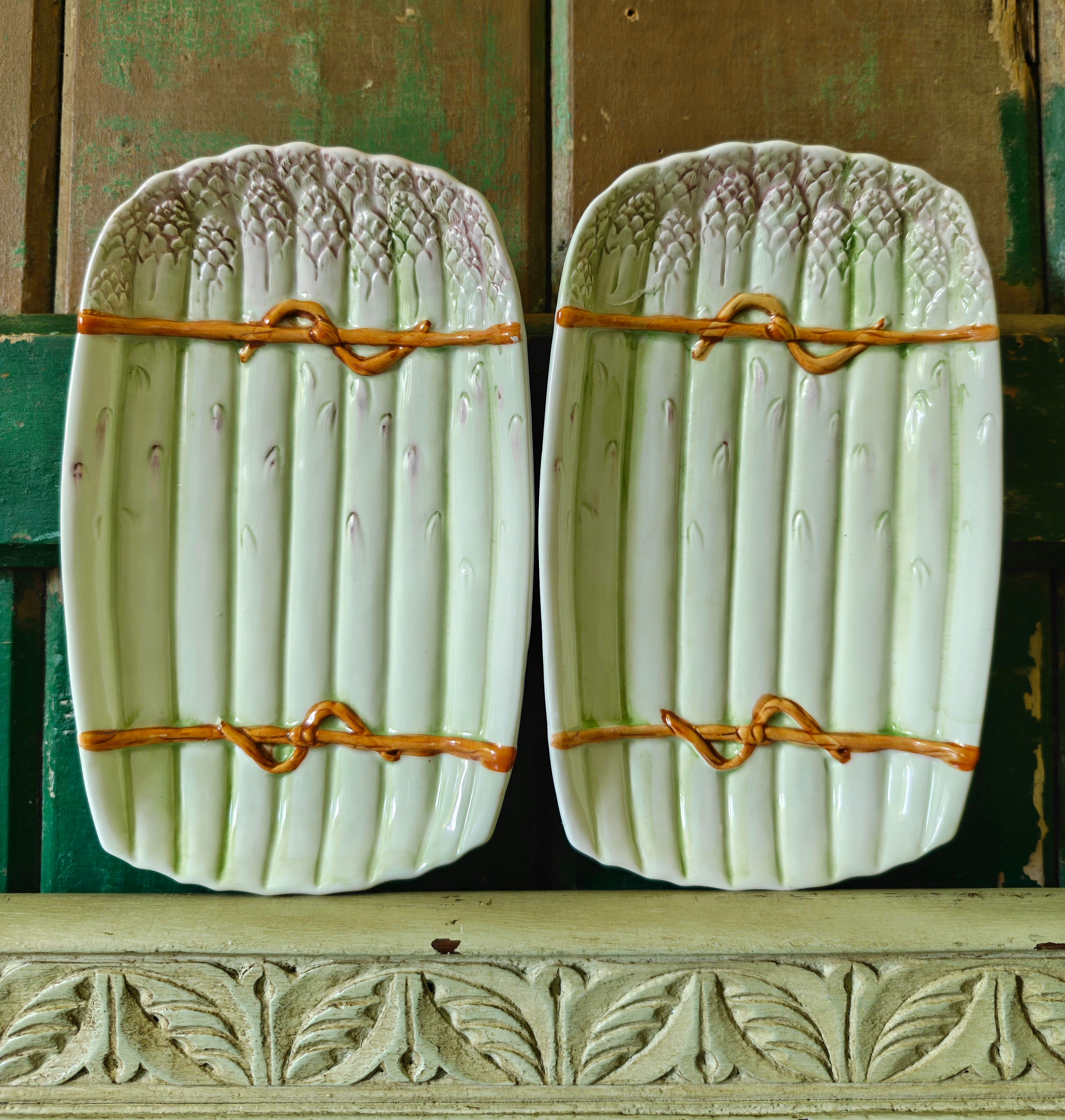 Two decorative green ceramic asparagus platters