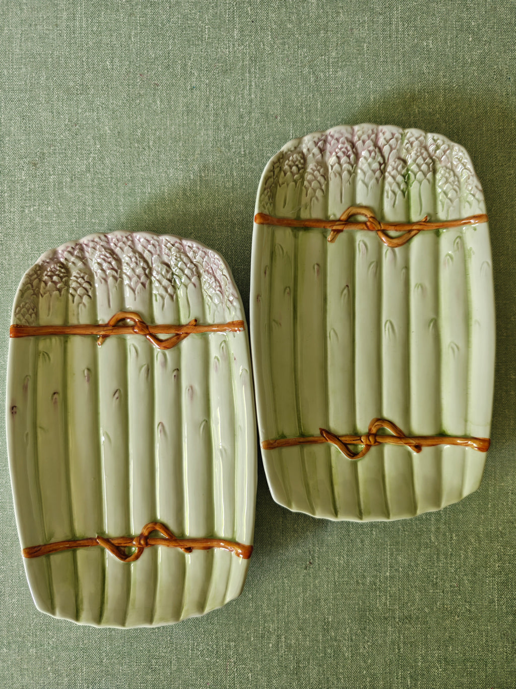 Two decorative green ceramic asparagus platters